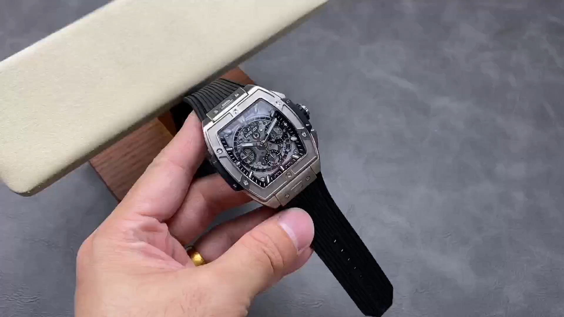 Strap in hand: Hublot Spirit of Big Bang 642.NX.0170.RX showing black rubber strap laid out. - Video