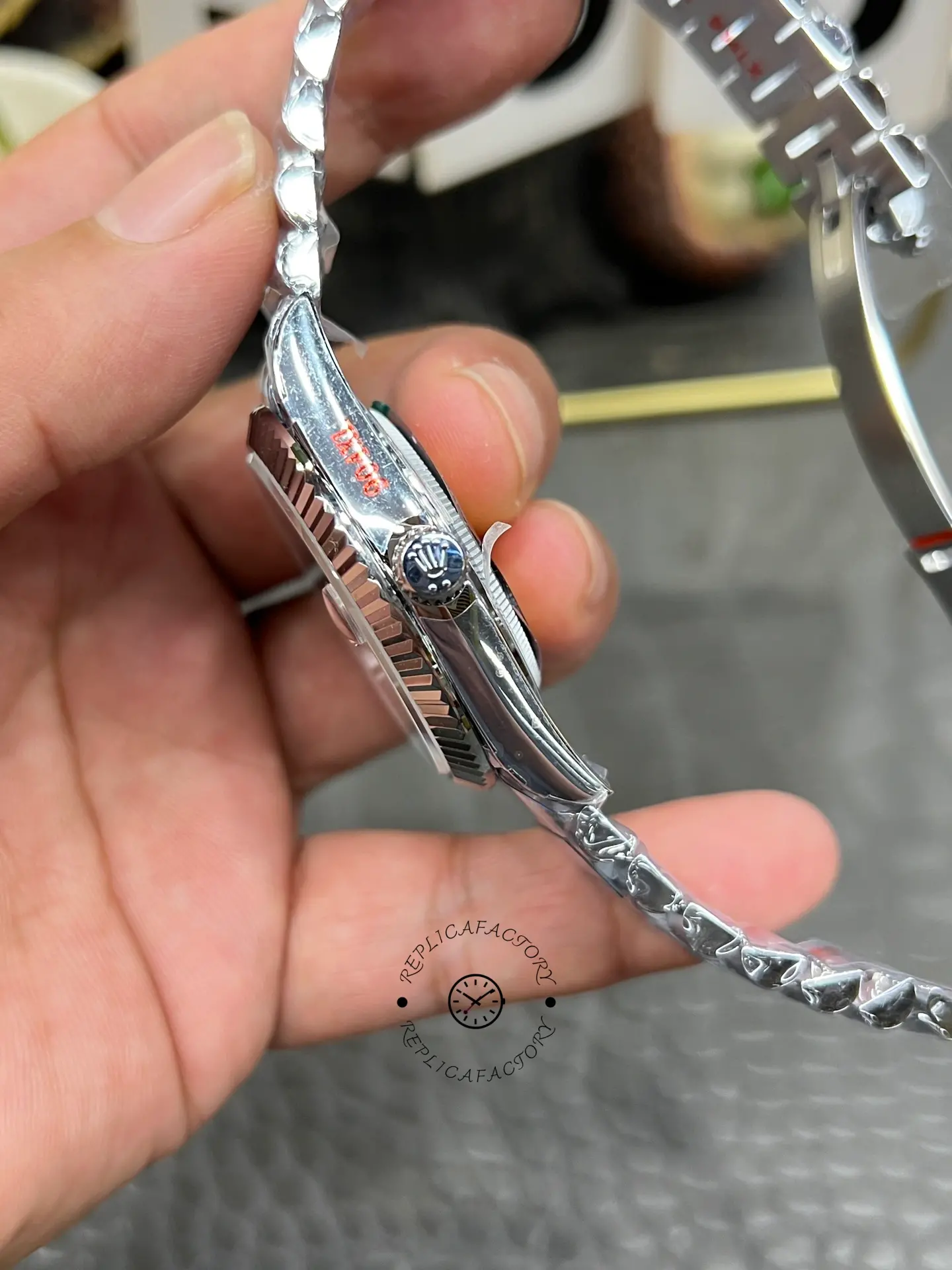 Side view of Rolex Day-Date 228239-0076 showing the fluted bezel profile and crown with Rolex-style logo.