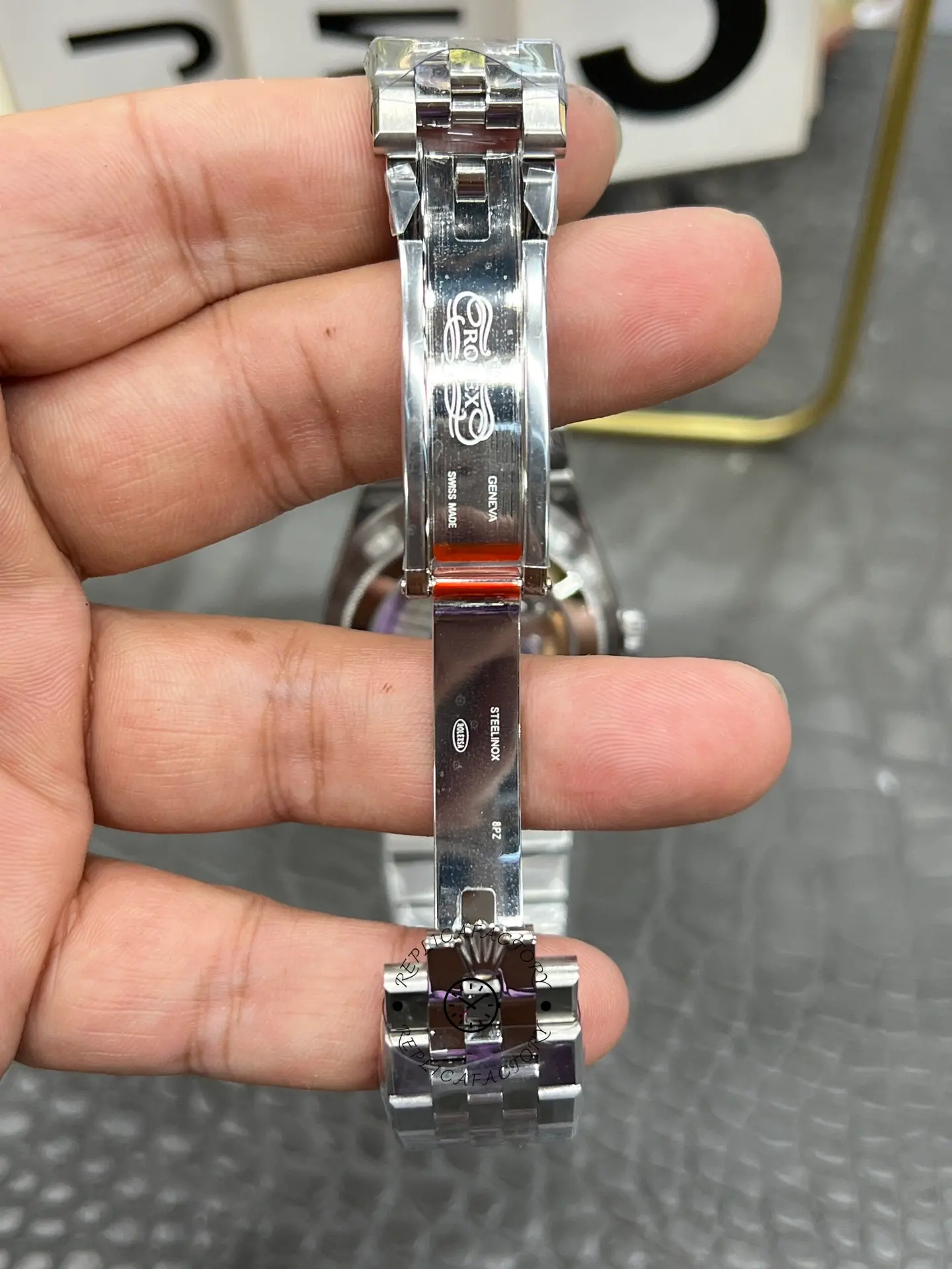 Open clasp view of Rolex Land-Dweller 40 M127334-0001 replica showing inner clasp engravings and folding mechanism.