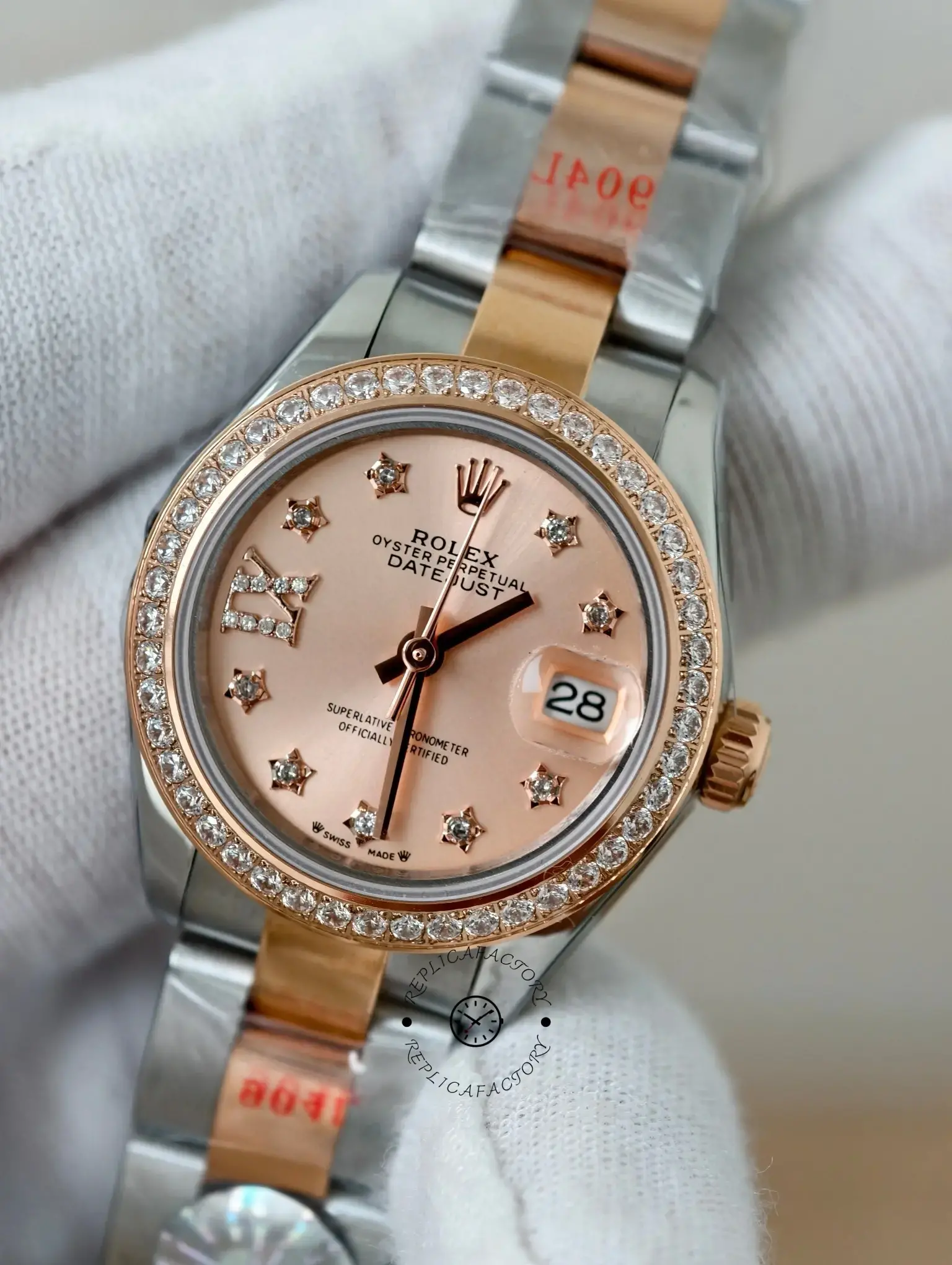 Close dial detail of Rolex Lady-Datejust 279381RBR-0028 with rose pink dial, diamond-set bezel, and cyclops date.