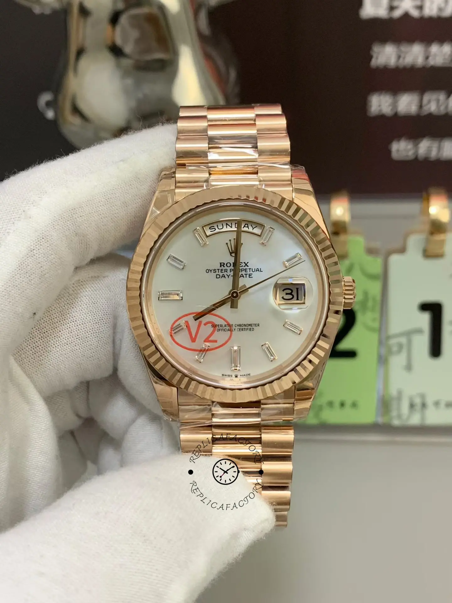 Front in-hand view of Rolex Day-Date 228235-0056 with white dial, baguette markers, and rose gold bracelet.