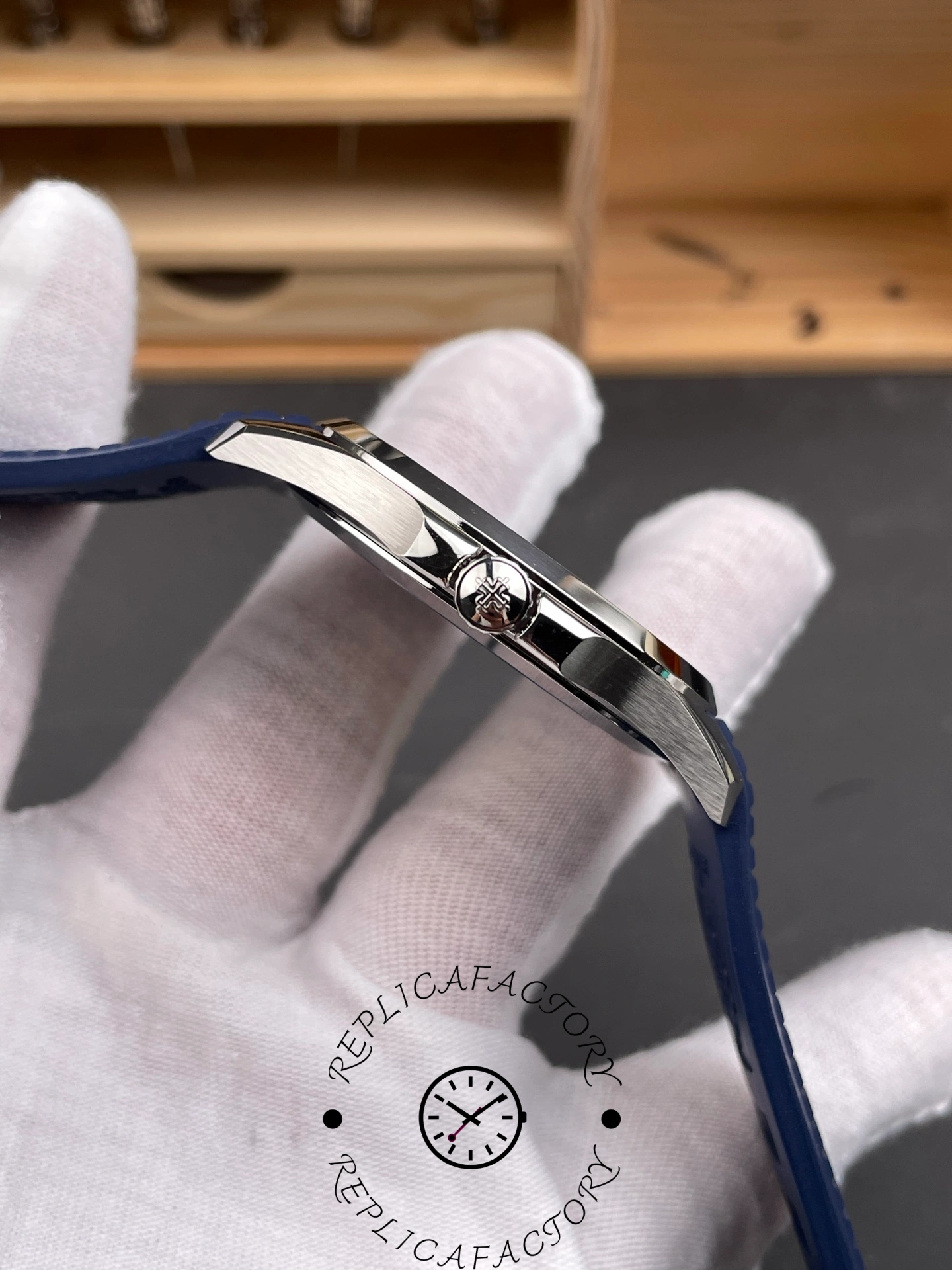 Crown detail of Patek Philippe 5168G-001 1:1 clone with engraved logo and polished edges.