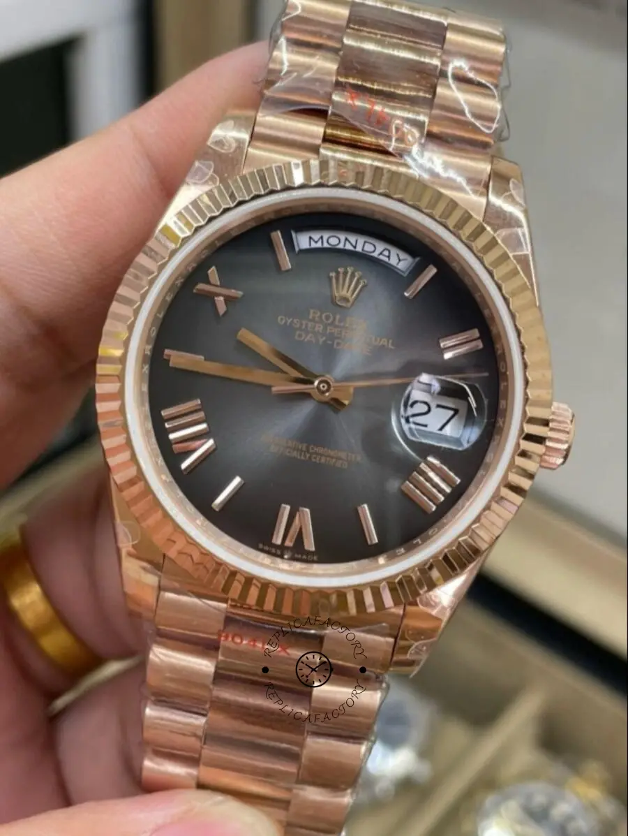 Angled front view of Rolex Day-Date 40 M228235-0055 with dark dial and Everose gold President bracelet.