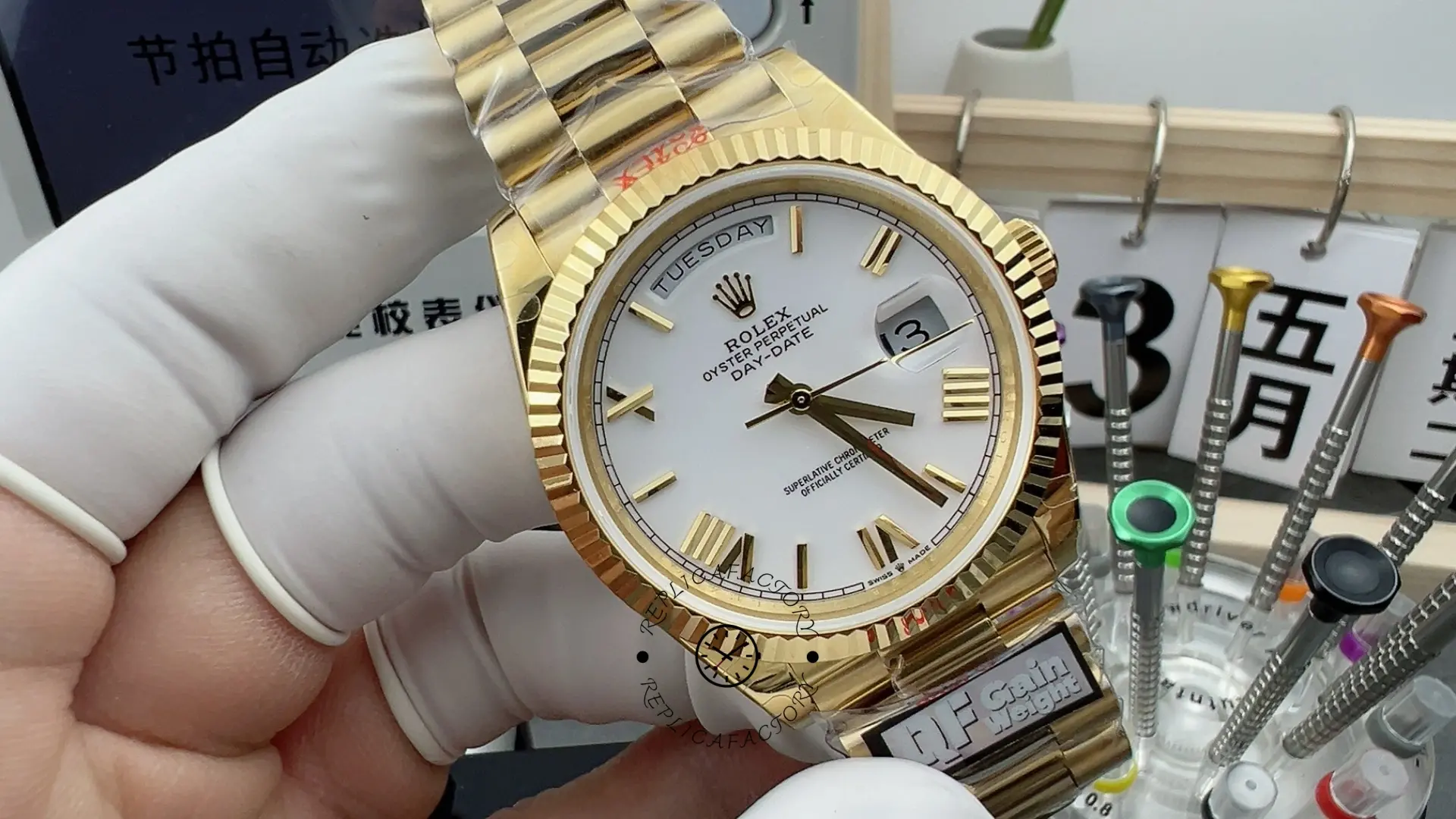 Close view of Rolex Day-Date 228238 showing white dial and gold-tone Roman-style hour markers.
