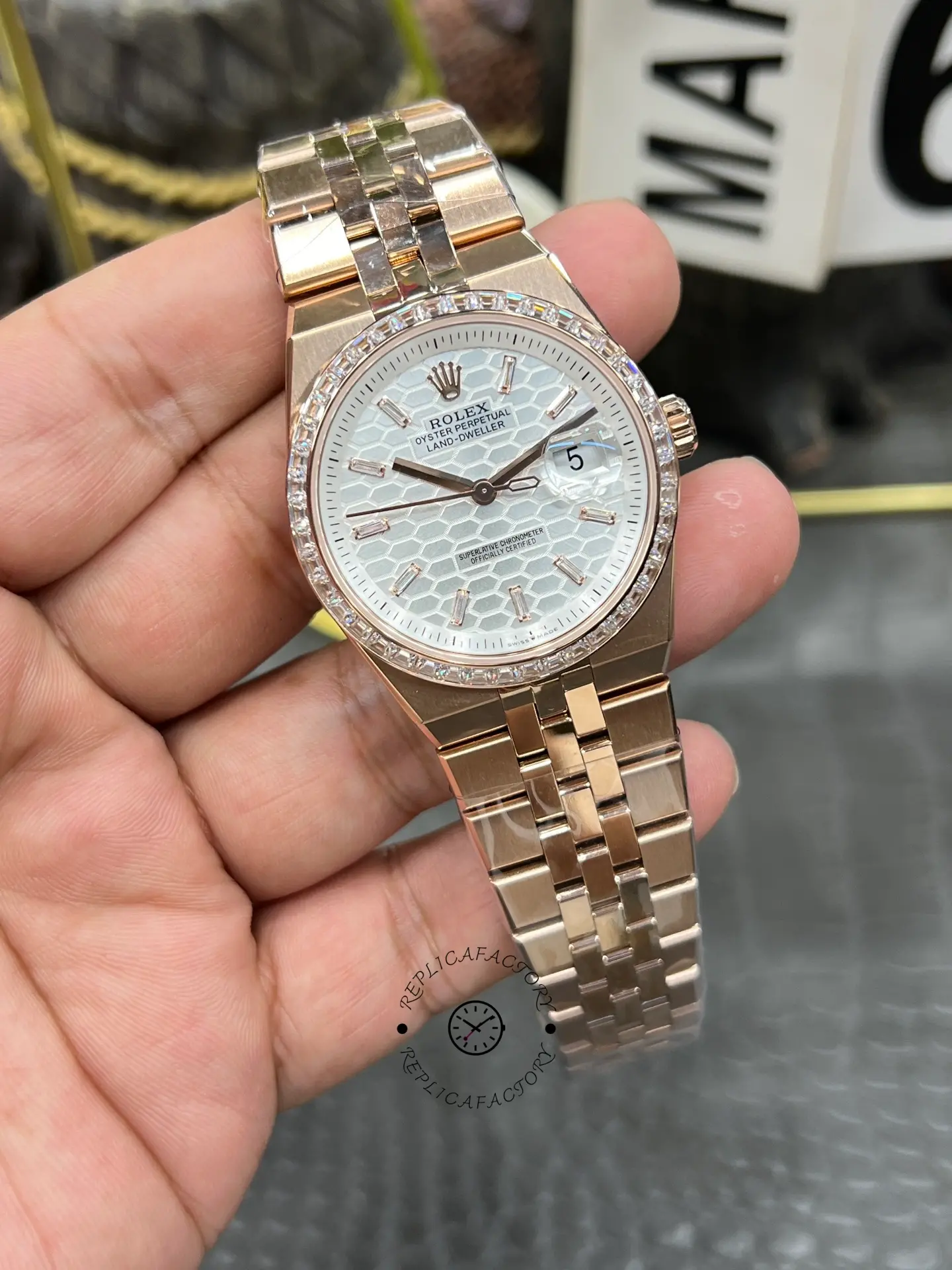 Straight front angle of Rolex Land Dweller m127385tbr-0003 with white textured dial and date magnifier.