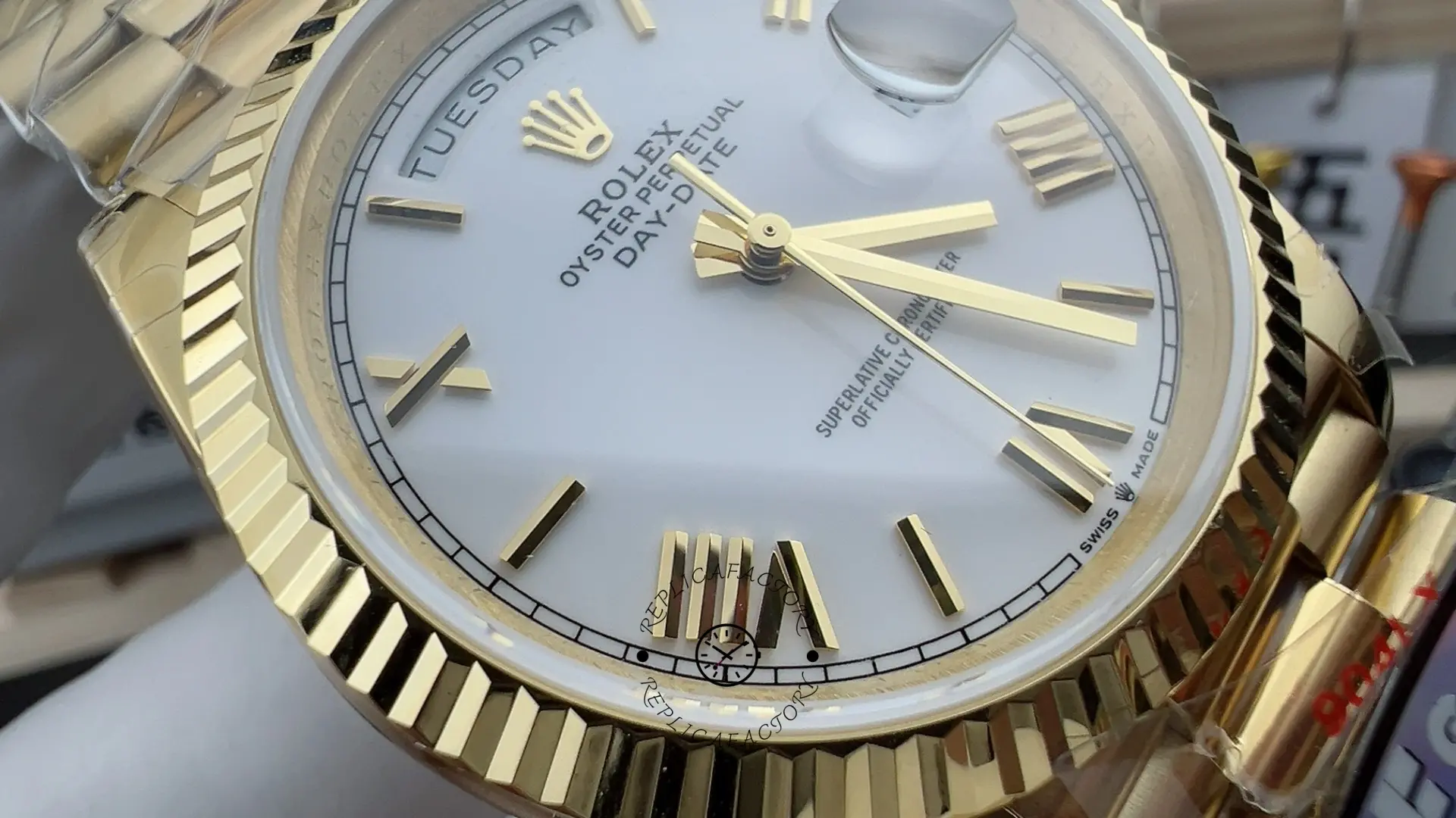 Dial close-up of Rolex Day-Date 228238 showing white dial, day display and polished hands.