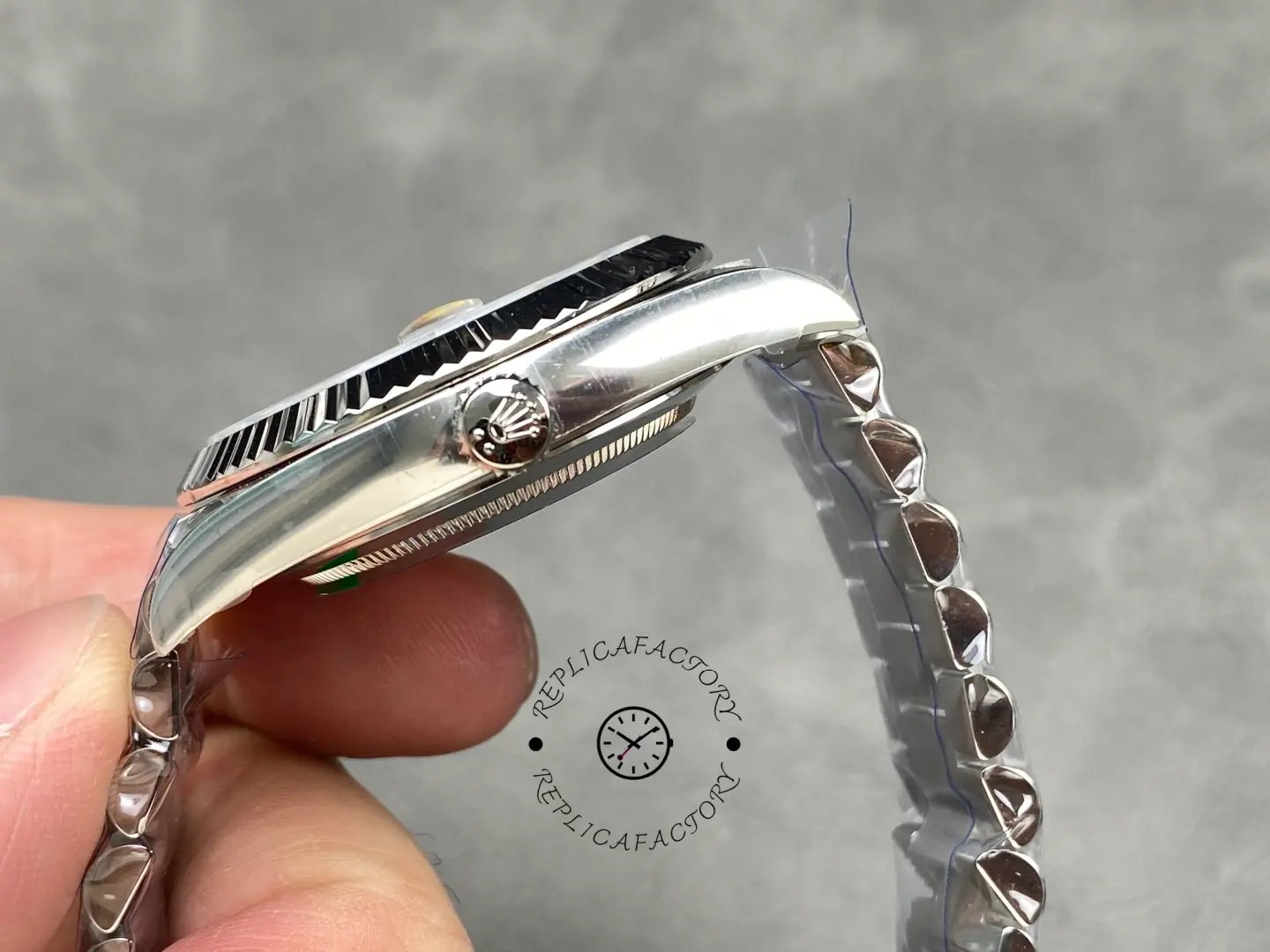 Rolex Day-Date 228239-0076 crown side view showing Rolex crown logo and fluted bezel edge