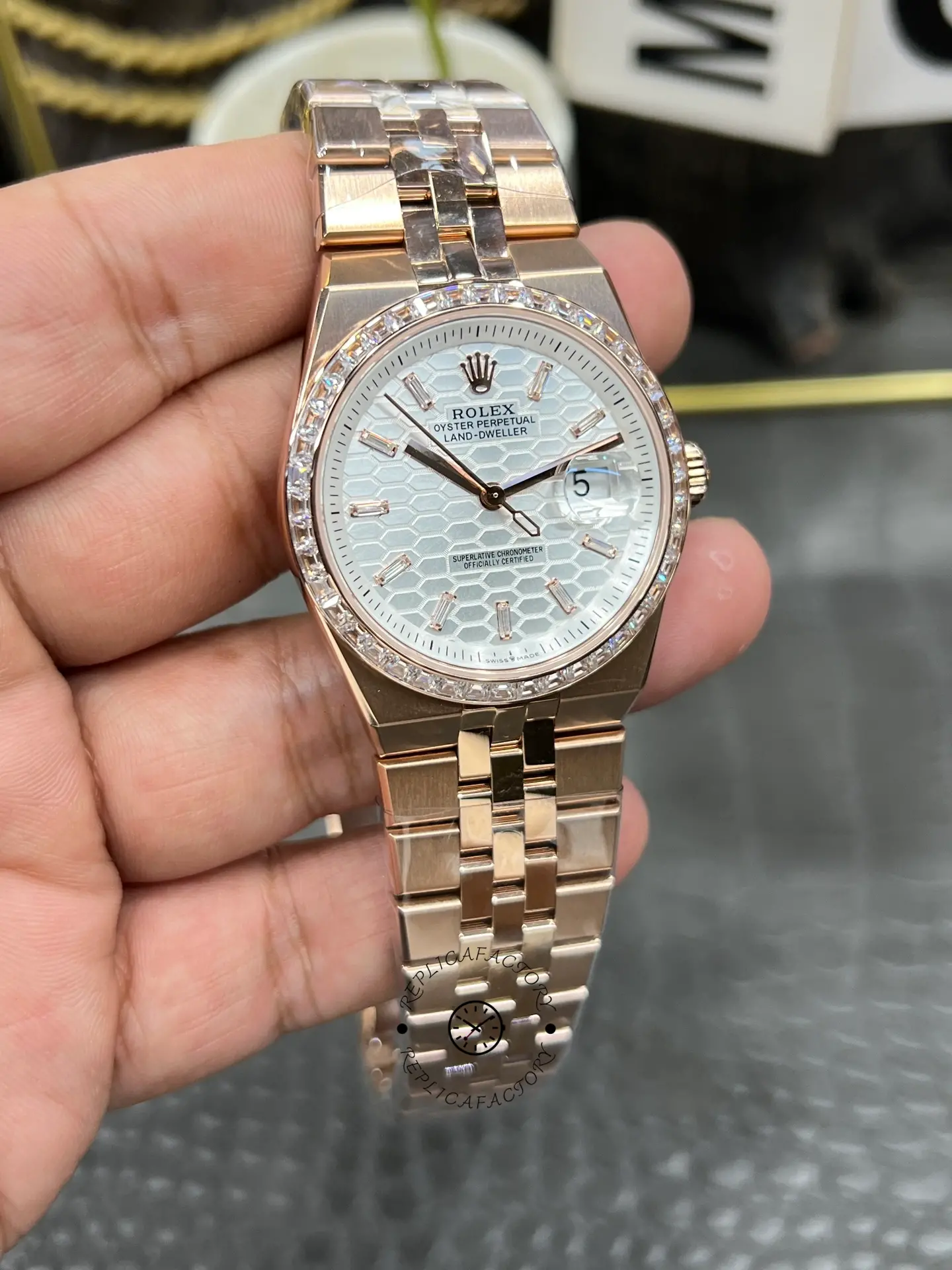Front-left view of Rolex Land Dweller m127385tbr-0003 showing the textured dial and integrated rose gold-tone bracelet.