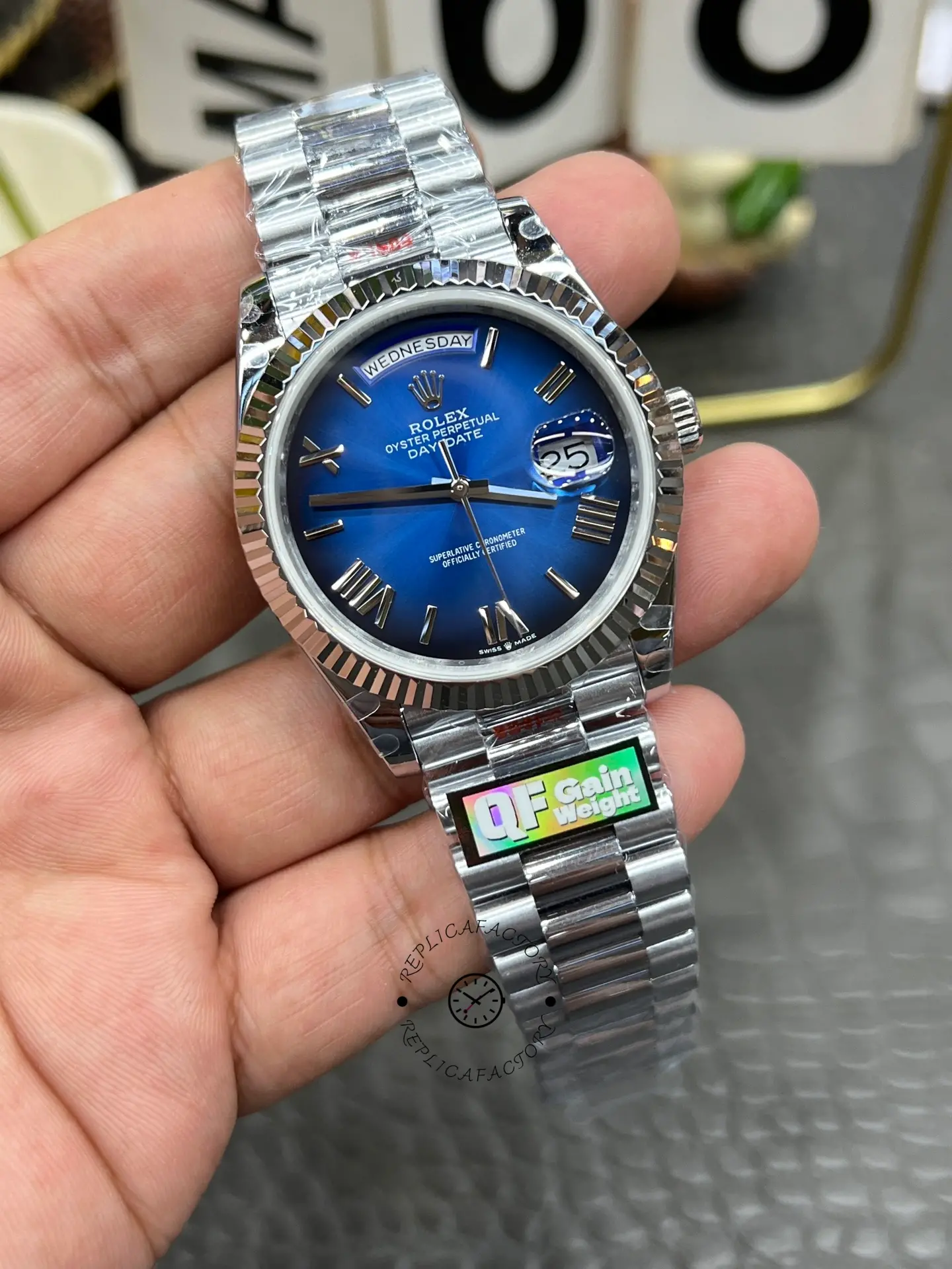 Front-left view of Rolex Day-Date 228239-0076 with blue ombré dial, fluted bezel, and polished bracelet.