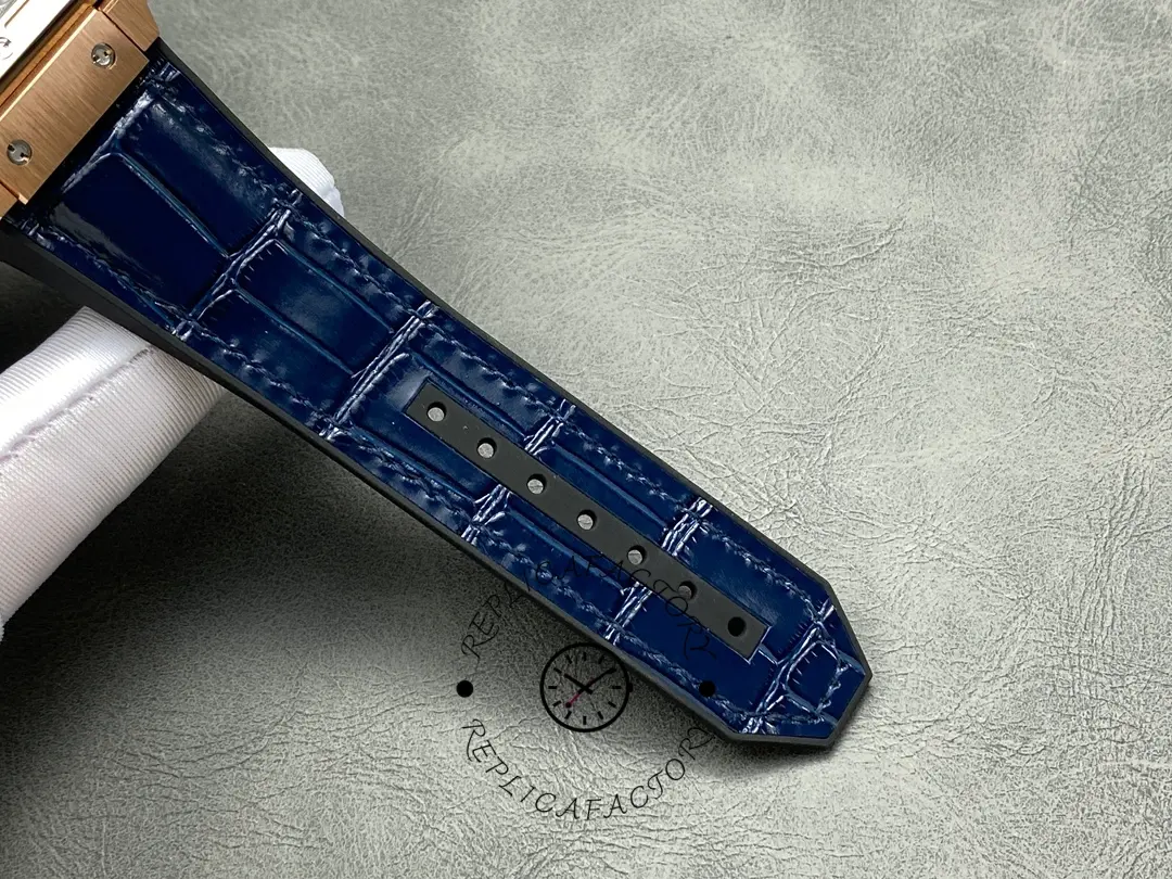Close-up of the blue leather strap tip on Hublot 601.OX.7180.LR showing stitching and adjustment holes.