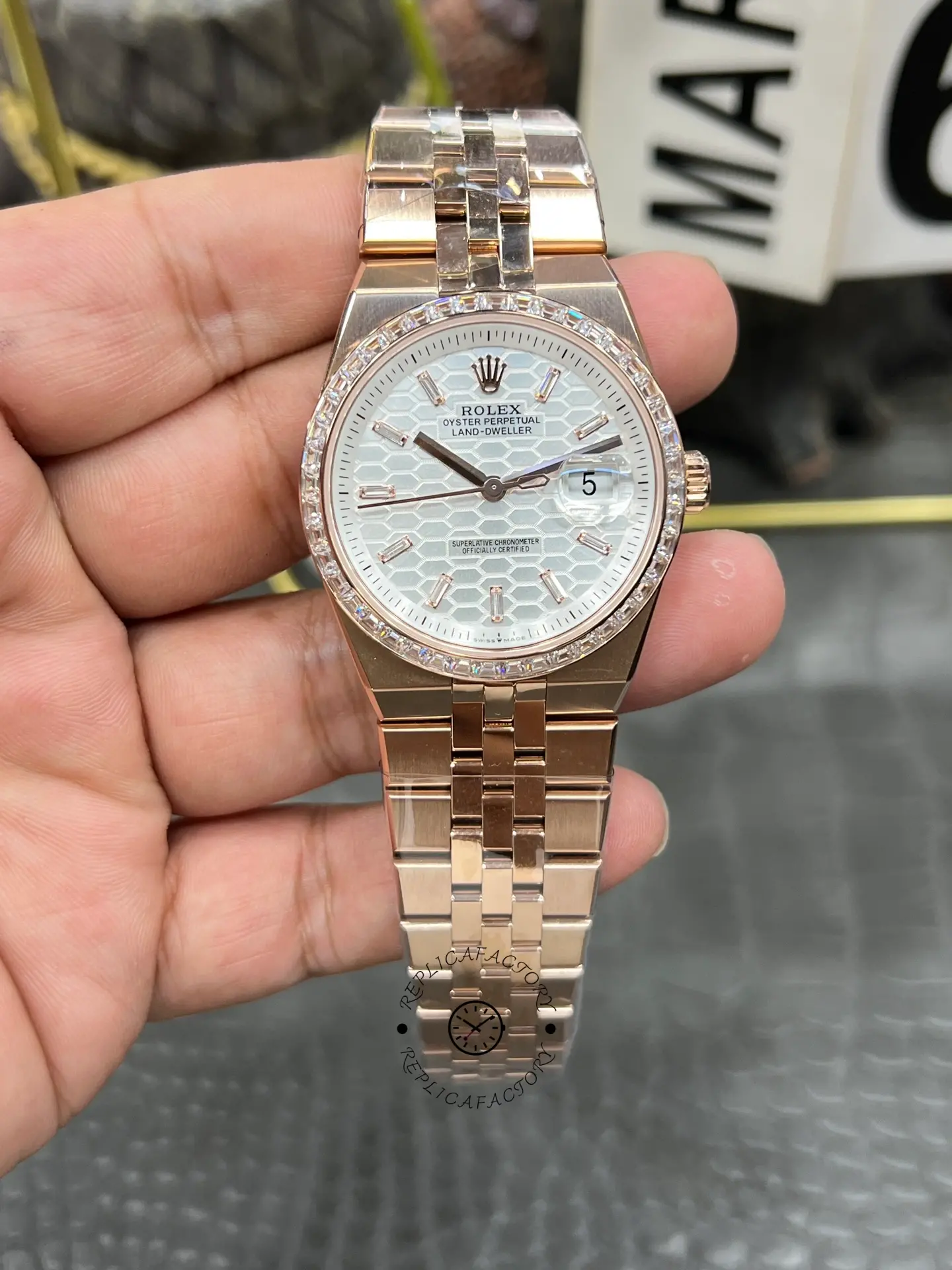 Front view of Rolex Land Dweller m127385tbr-0003 with honeycomb dial, diamond-set bezel, and rose gold-tone bracelet.