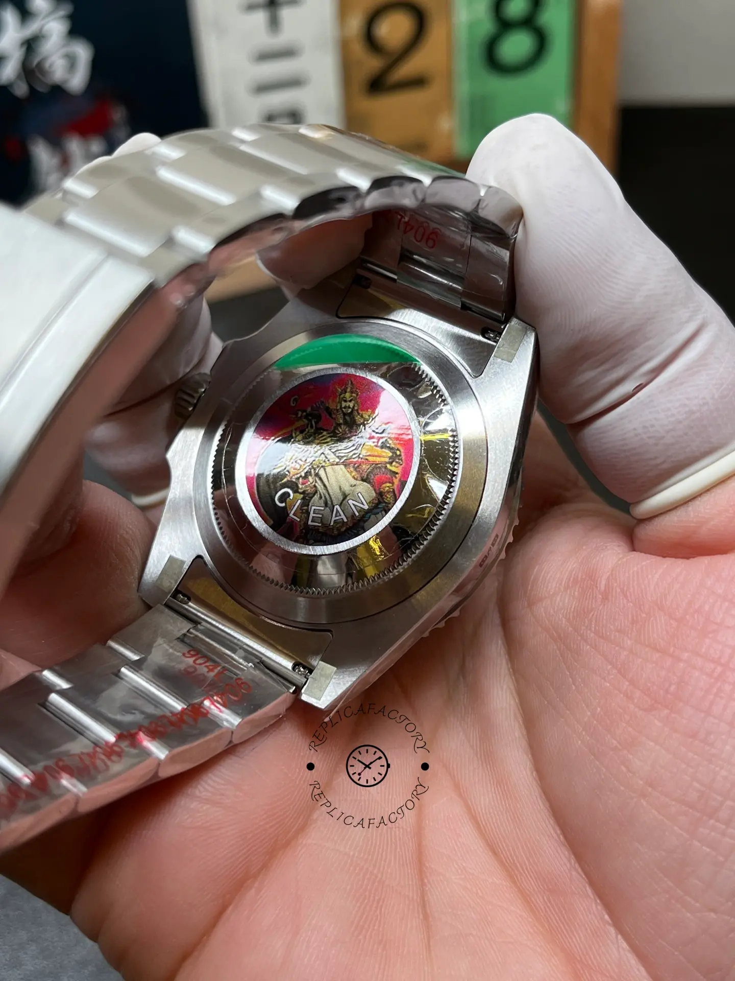 Rear caseback view of Rolex 116610LV Submariner Date with CLEAN sticker and Oyster bracelet.