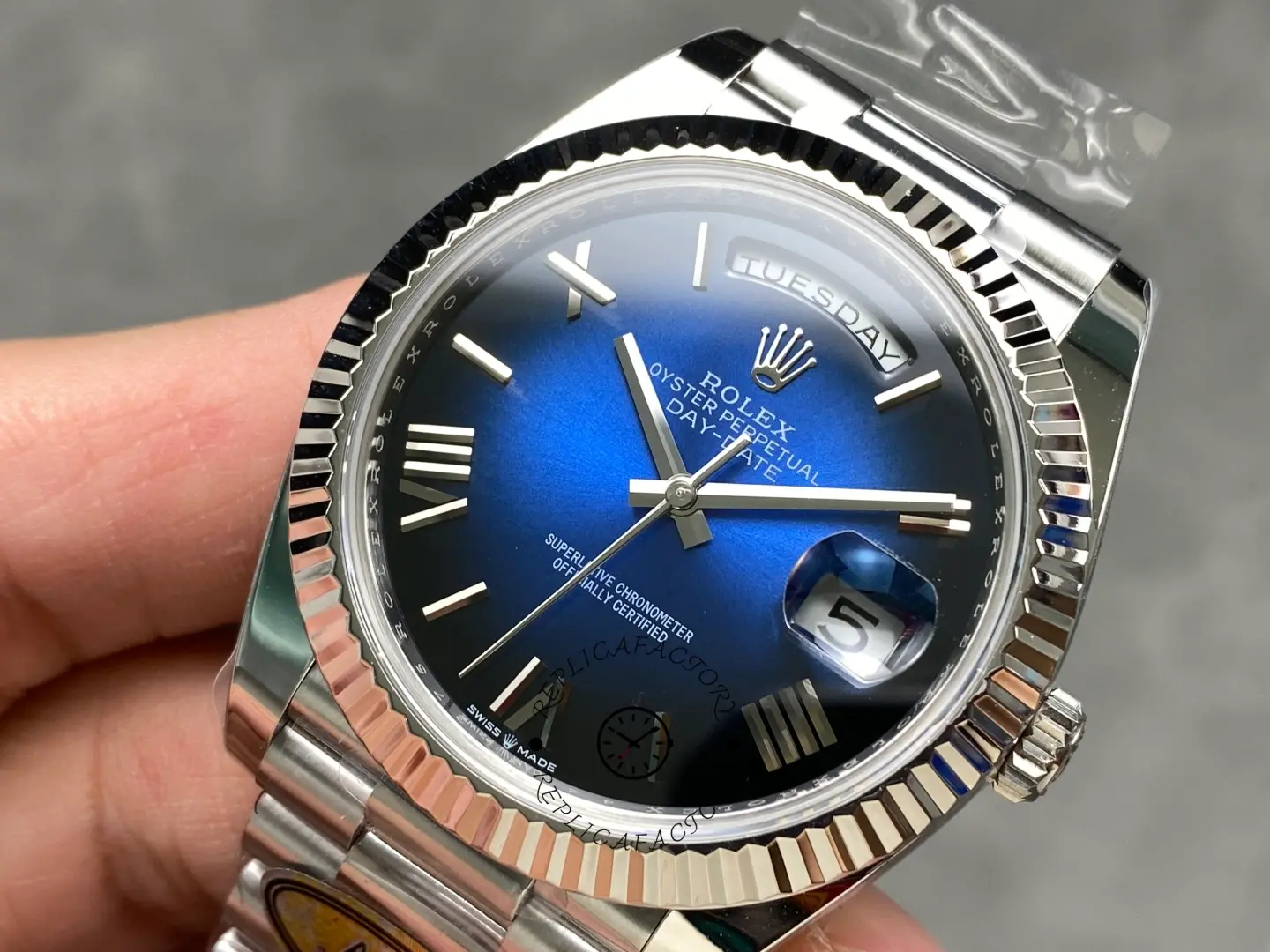 Rolex Day-Date 228239-0076 angled dial view highlighting blue gradient dial and polished case