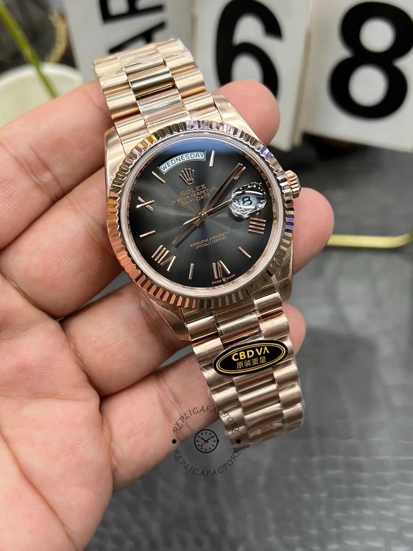 Angled front view of Rolex Day-Date 40 M228235-0055 showing the day window, date magnifier and fluted bezel.