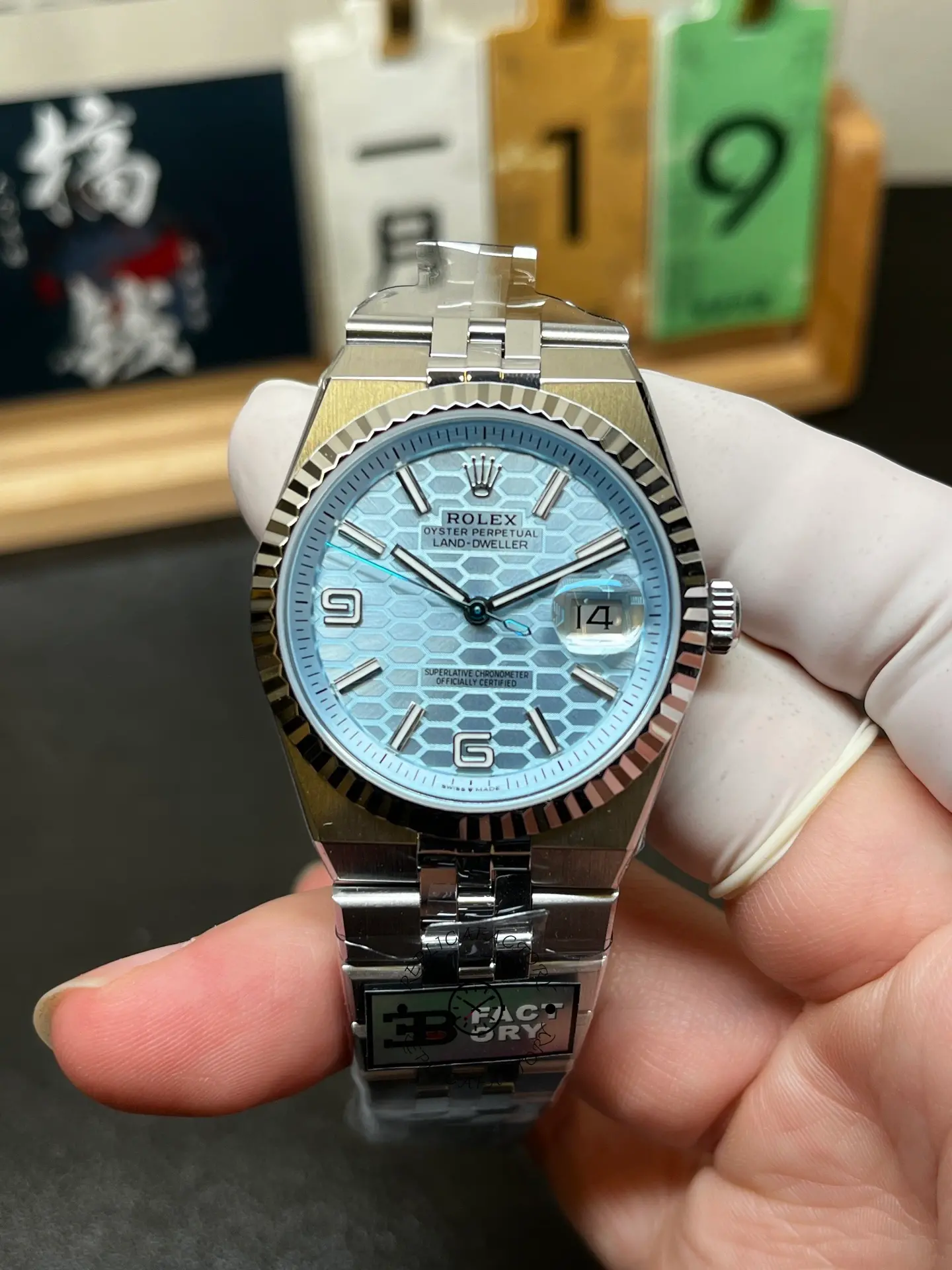 Front view of Rolex Land-Dweller 40 127336-0001 with ice blue honeycomb dial and fluted bezel.
