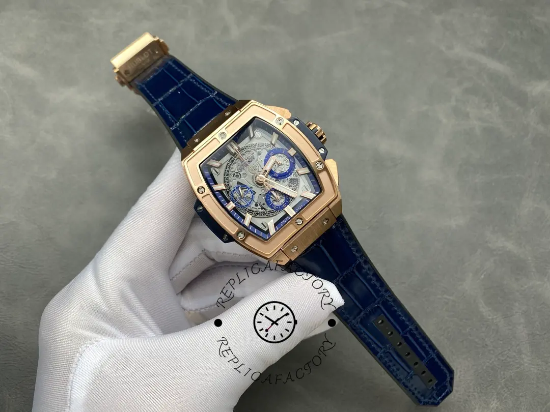 Full watch view of Hublot 601.OX.7180.LR showing blue leather strap and tonneau case on a gloved hand.