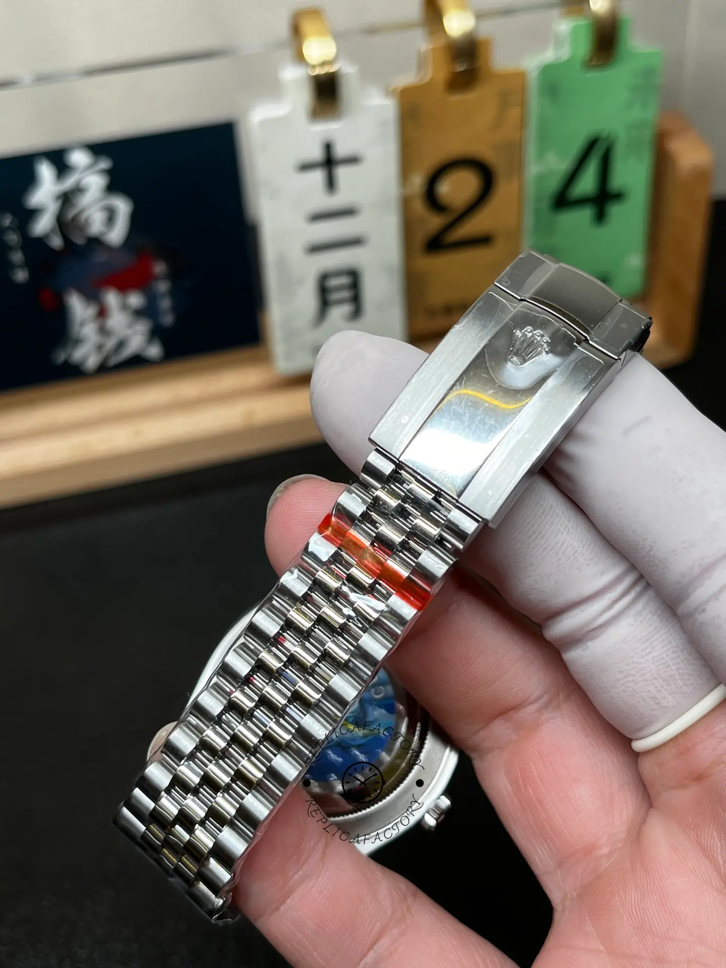 Close-up of Rolex 126334-0018 clasp showing brushed clasp cover and Jubilee bracelet links.