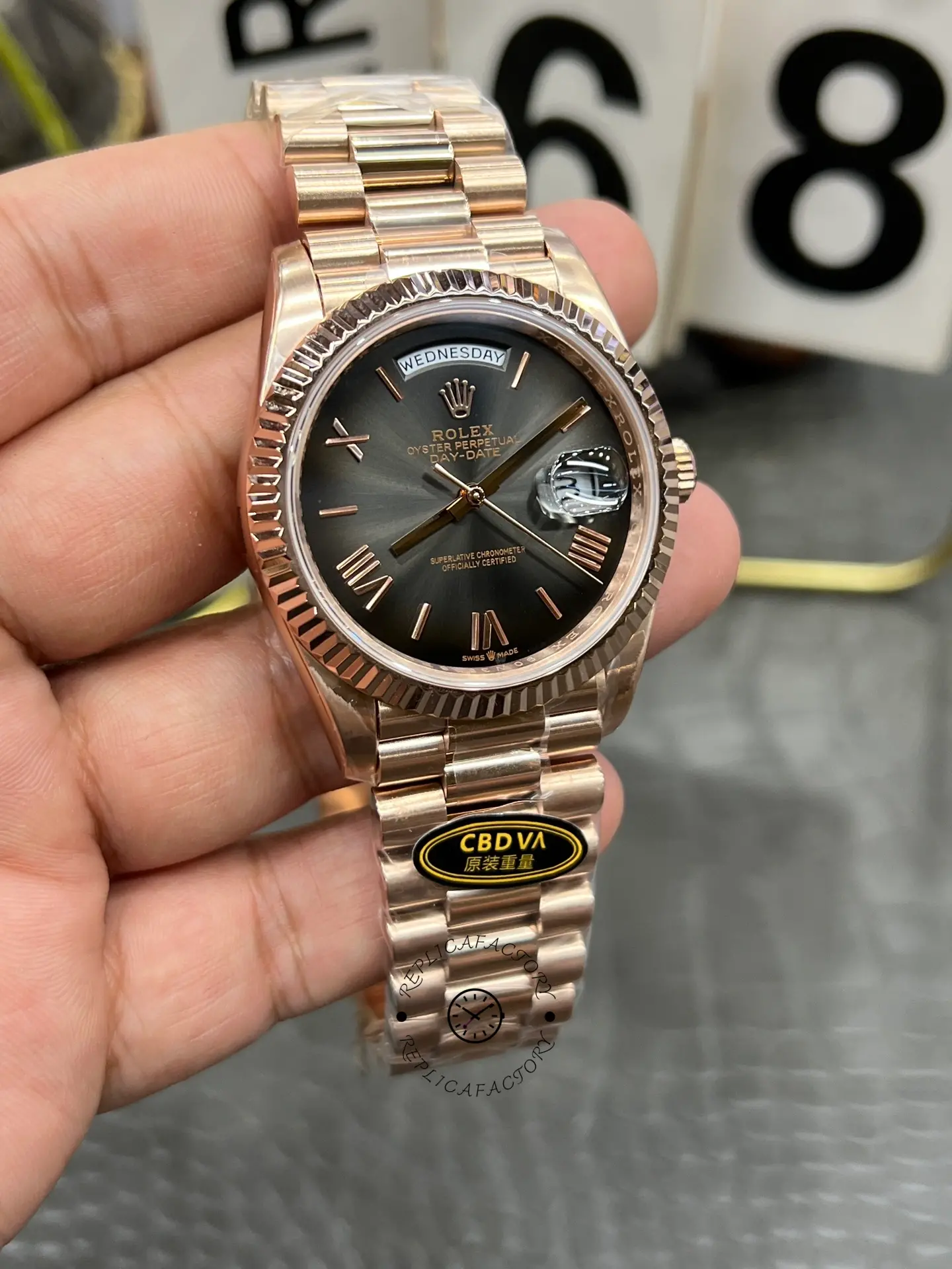 Straight front shot of Rolex Day-Date 40 M228235-0055 with slate sunburst dial and President-style bracelet.