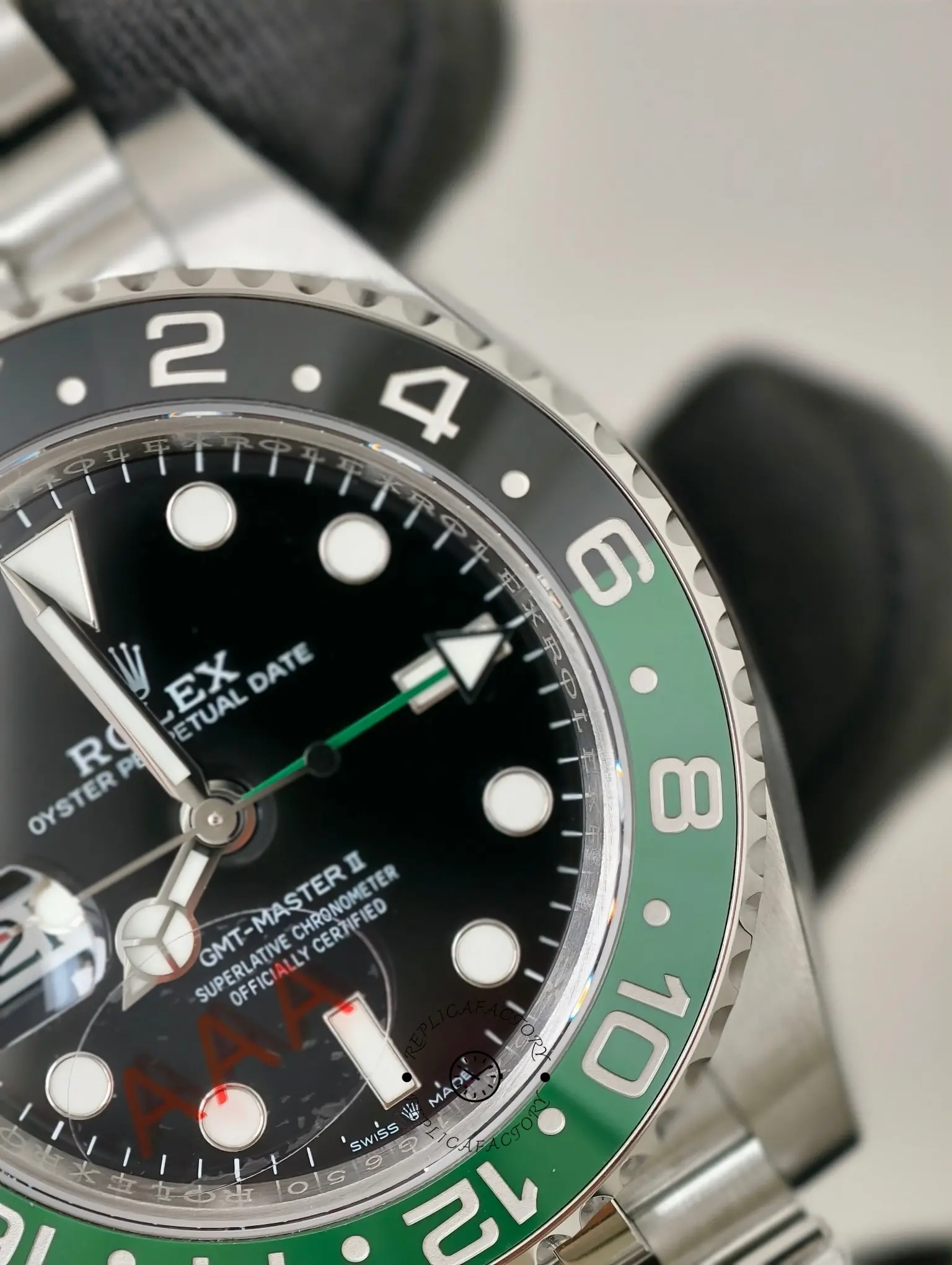 Close-up of Rolex GMT-Master II 126720VTNR black dial with green GMT hand and black-green 24-hour bezel.