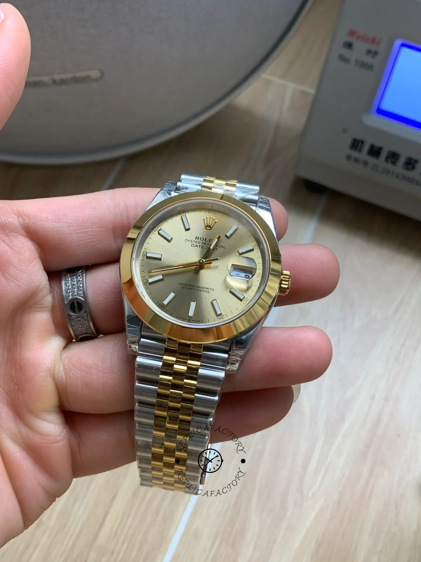 Angled front view of Rolex Datejust 41 126303-0010 showing champagne dial and Cyclops date magnifier.