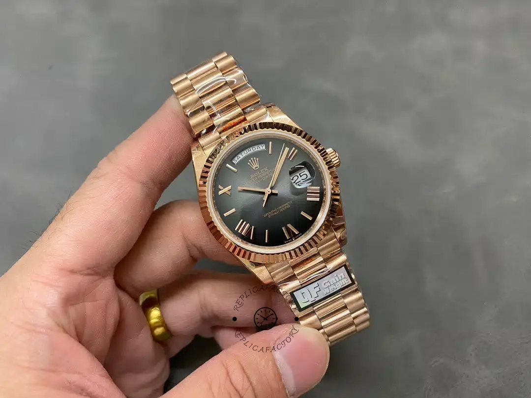Full handheld view of Rolex Day-Date 40 M228235-0055 with dark dial and Everose gold President bracelet.