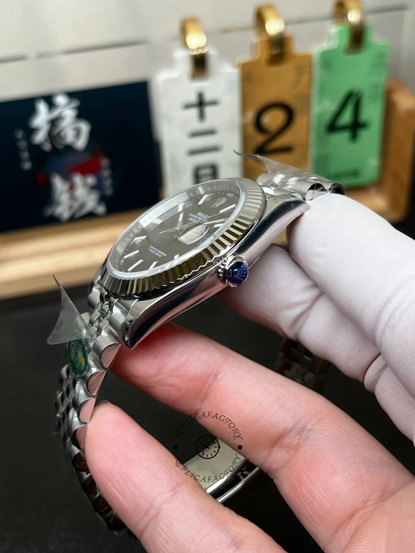 Crown-side angled view of Rolex 126334-0018 showing fluted bezel, polished case and blue protective crown film.