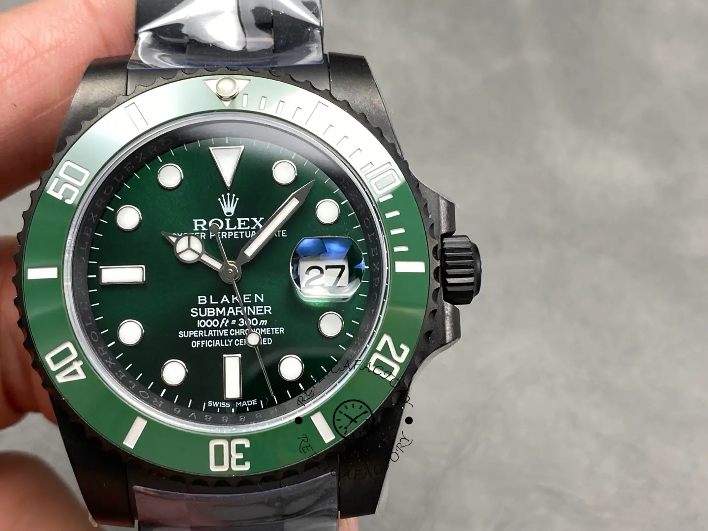 Front close-up of Rolex Submariner 116610LV with green dial, ceramic bezel and magnified date window.