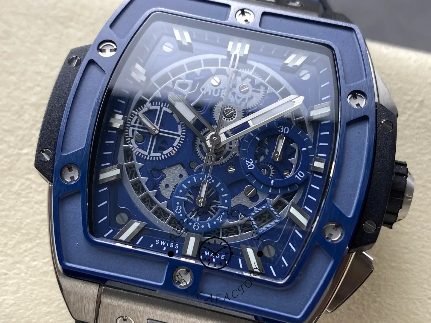 Dial macro of Hublot 642.NL.7170.RX highlighting skeleton bridges, blue sub-dials, and bezel screws.
