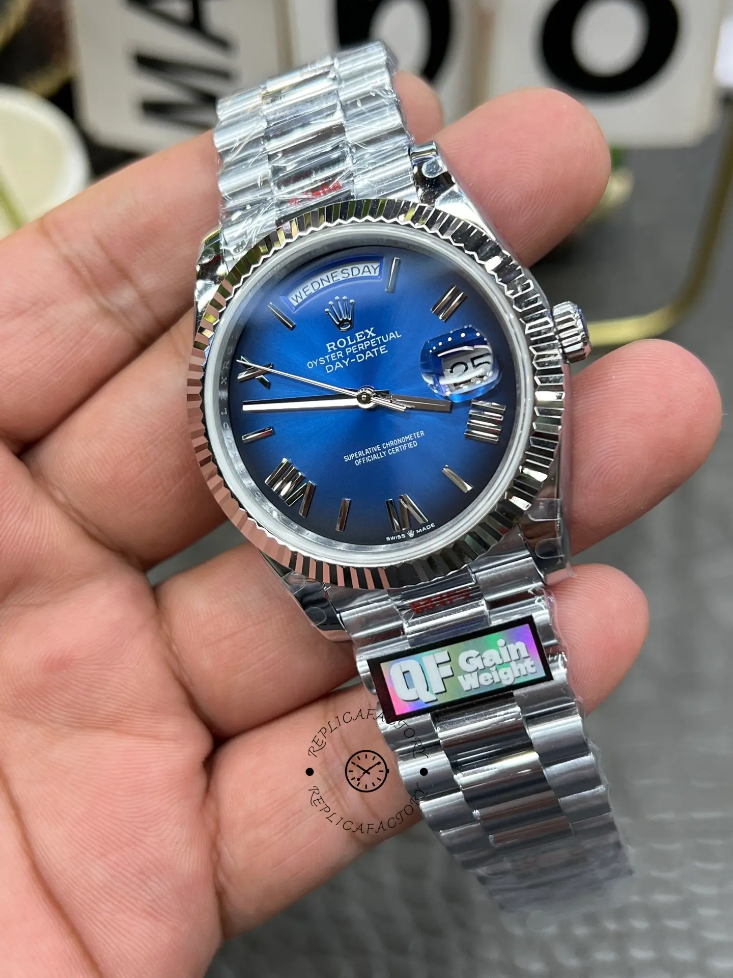 Front view of Rolex Day-Date 228239-0076 with blue ombré dial, fluted bezel, and silver-tone bracelet.