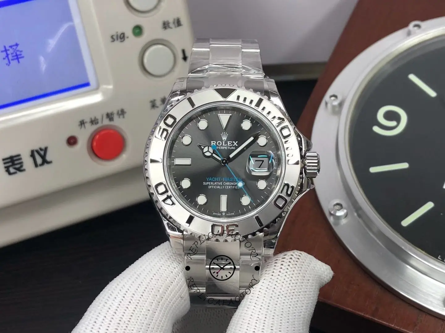 Front view of Rolex 126622-0001 with dark rhodium dial, platinum-style bezel and Oyster bracelet held in hand.