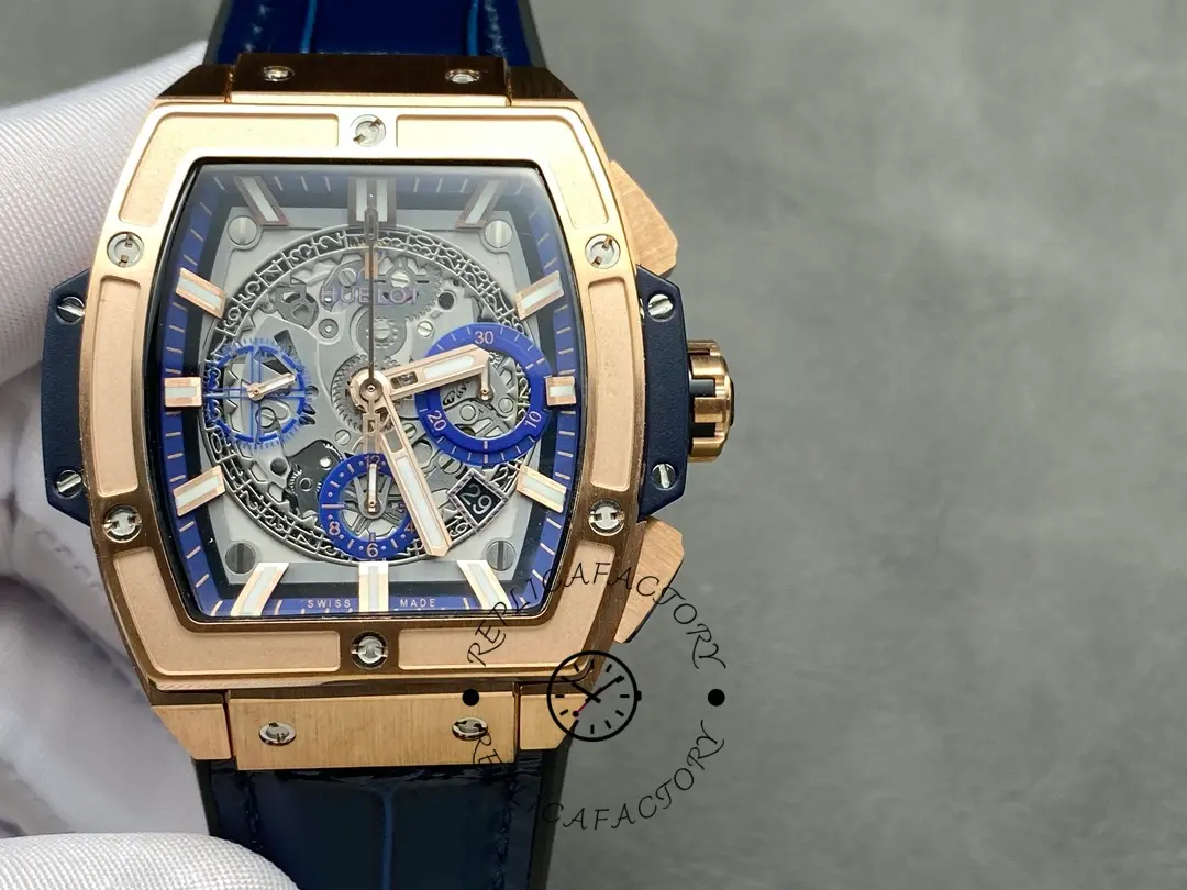 Gloved wrist shot of Hublot 601.OX.7180.LR highlighting the skeleton dial and blue chapter ring.