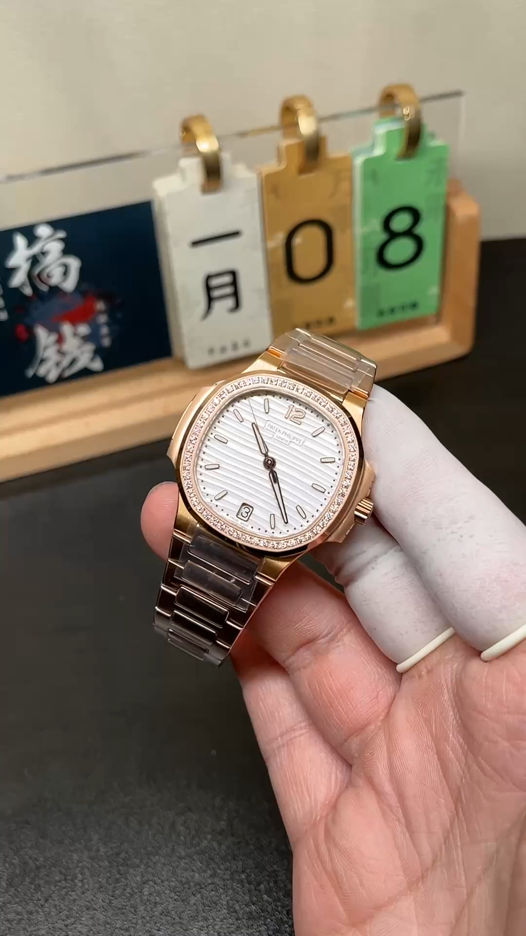 Video: hand-held Patek Philippe Nautilus 7118/1200R-001 showing diamond bezel sparkle and bracelet shine. - Video