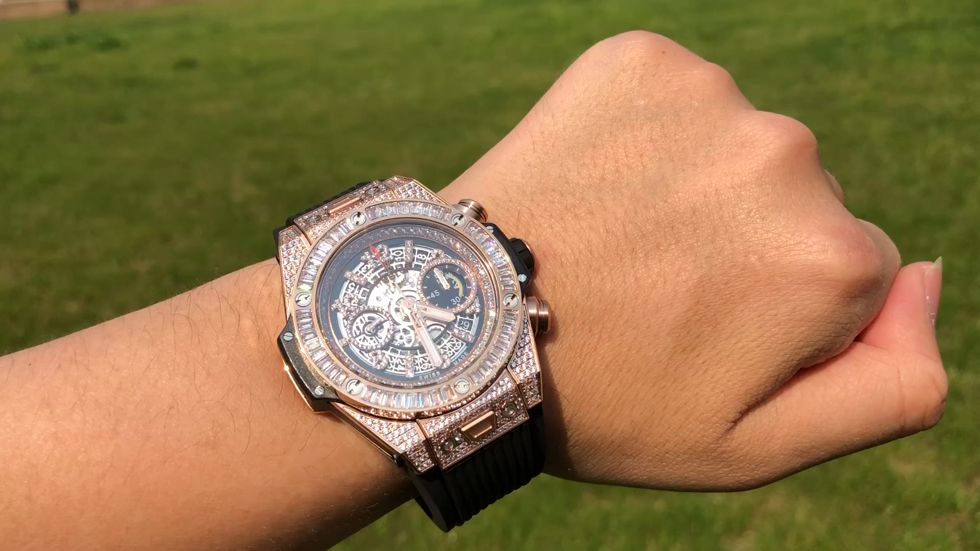 Wrist shot of Hublot Big Bang 421.OX.1180.RX.0904 showing rose gold case and diamond-set bezel outdoors. - Video