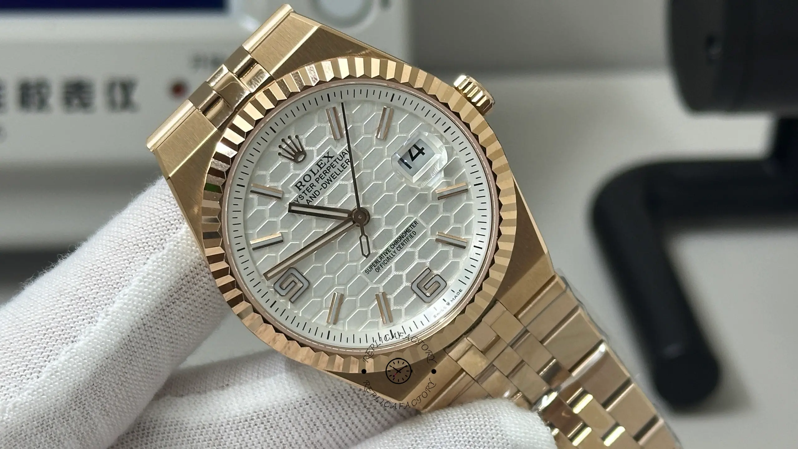 Close-up view of Rolex Land-Dweller M127235-0001 showing the honeycomb dial, fluted bezel, and Cyclops date lens.