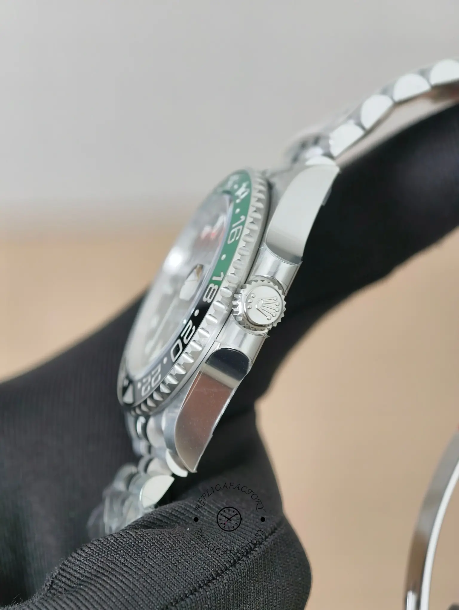 Side view of Rolex GMT-Master II 126720VTNR showing the left-hand crown, case profile, and bezel edge.