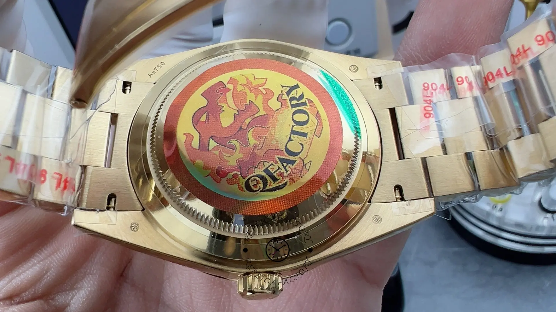 Open back view of Rolex Day-Date 228238 showing case back sticker and bracelet interior.