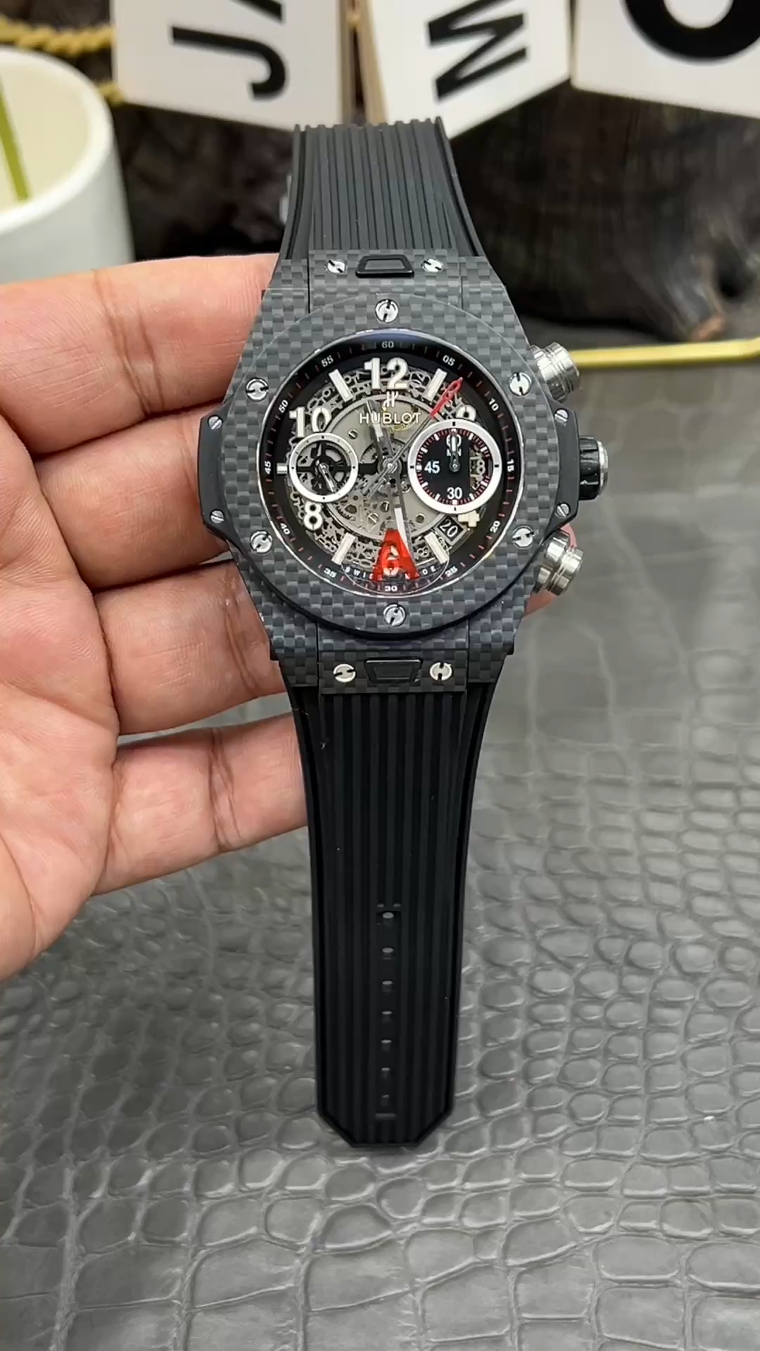 Hublot Big Bang UNICO 411.QX.1170.RX hand-held front view, skeleton dial with red accents. - Video