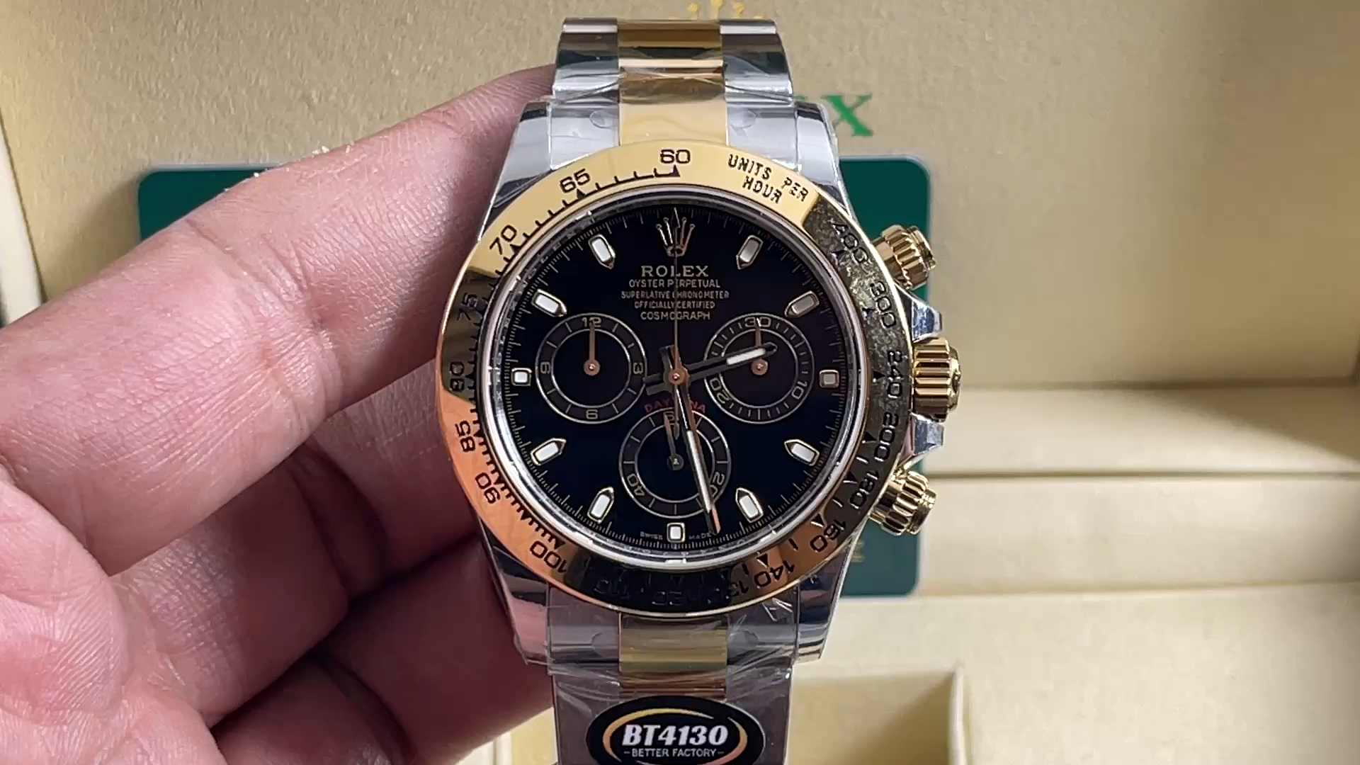 Video: hand holding Rolex Cosmograph Daytona 116503, black dial and gold bezel visible. - Video