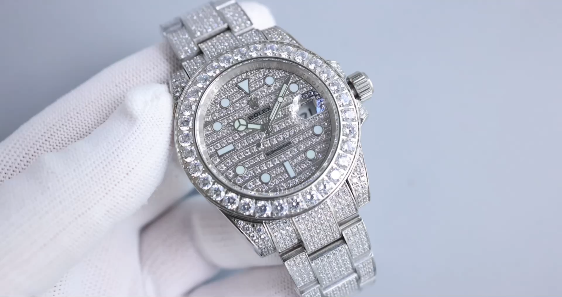 Rolex Submariner 116610LN, diamond-clad watch held in hand. - Video