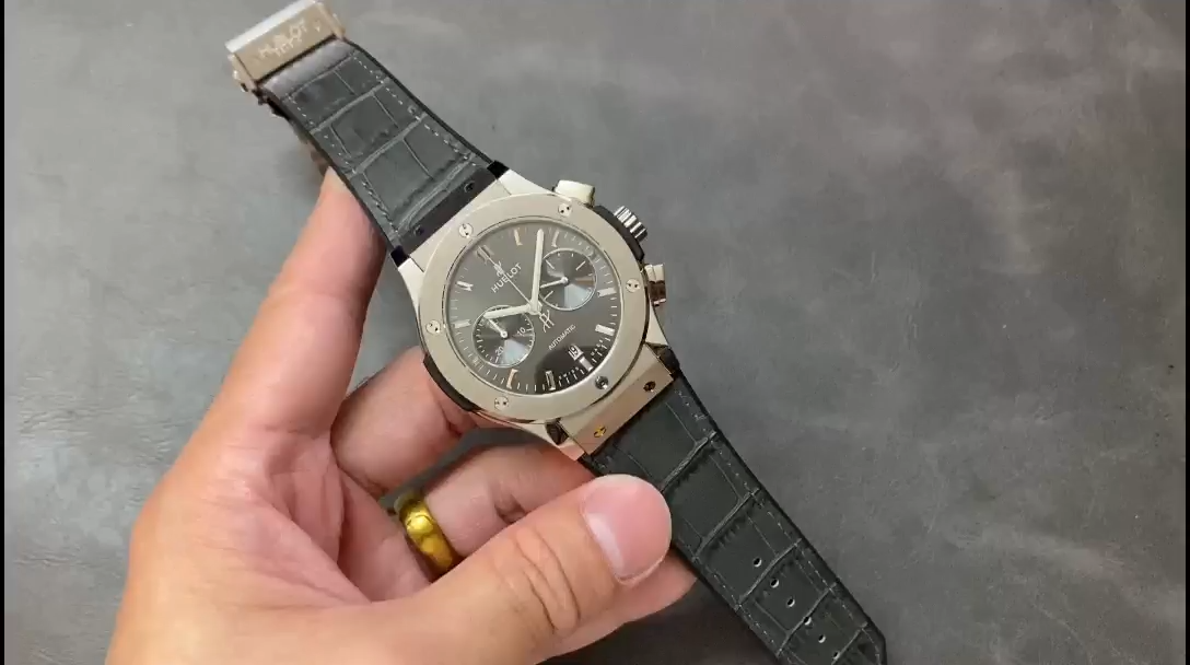 Video thumbnail of Hublot 521.NX.7071.LR strap held in hand with play icon. - Video