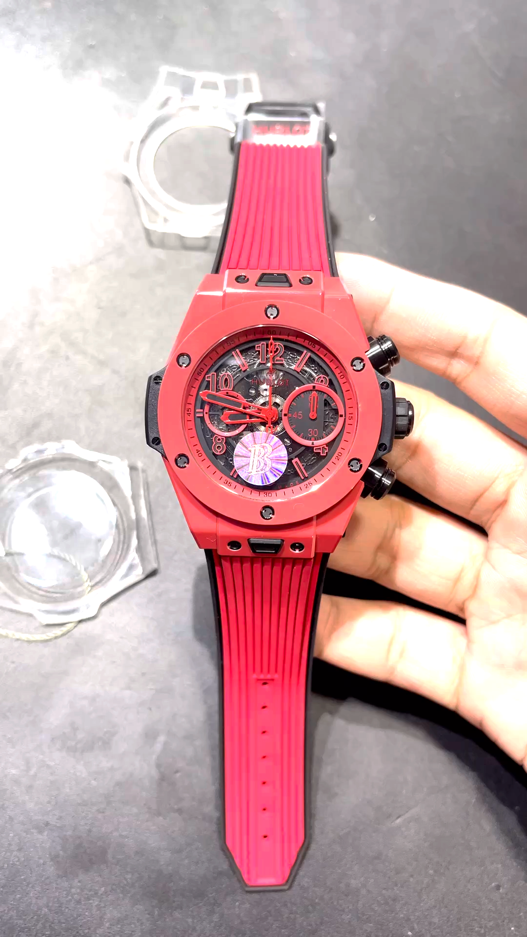 Wrist photos of the Hublot Big Bang Unico Red Magic Ceramic 411.CF.8513.RX with a red rubber strap. - Video