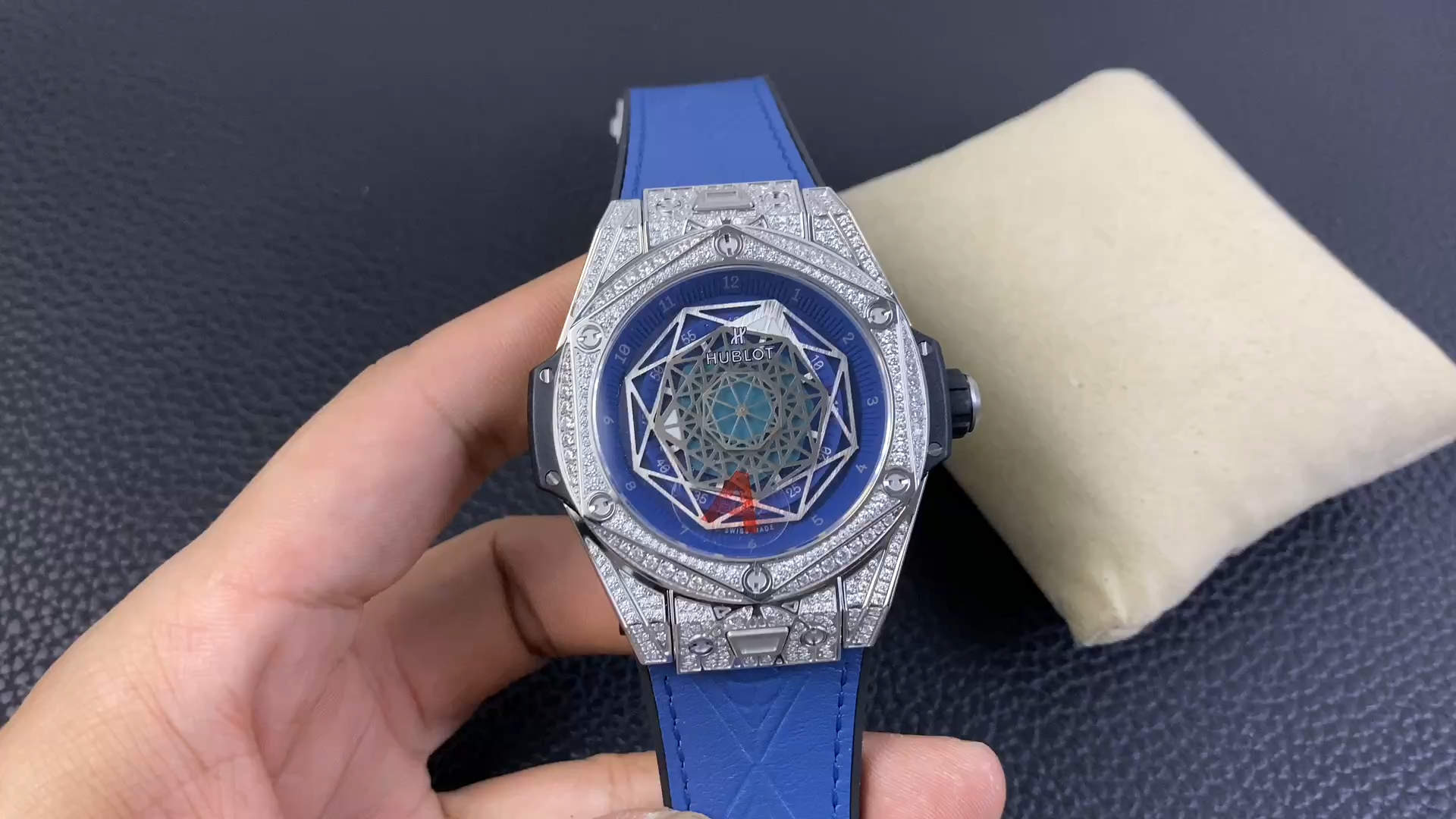 In-hand close-up of the Hublot Big Bang Sang Bleu 415.NX.7179.VR.1704.MXM18 dial, layered Sang Bleu geometry. - Video
