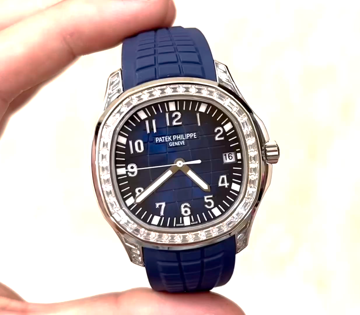 Video: hand-held Patek Philippe Aquanaut 5167/300G-010 showing diamond bezel sparkle and strap texture. - Video