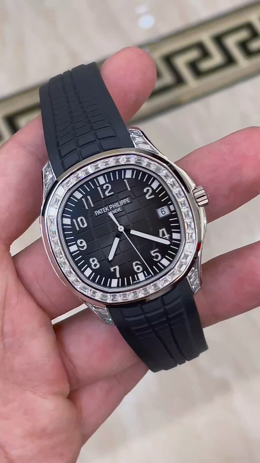Video: hand-held Patek Philippe Aquanaut 5167/300G-010 showing black dial and strap texture. - Video