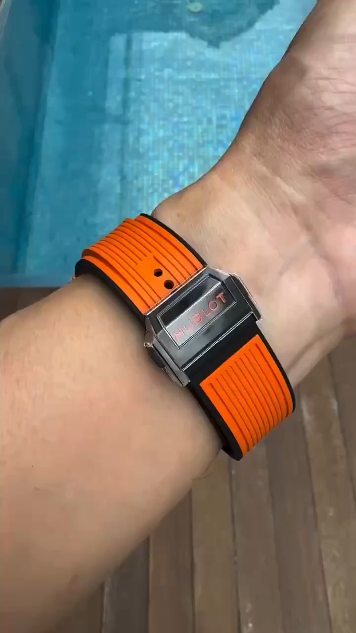 Wrist shot of Hublot Big Bang Unico 441.CU.5910.RX showing bright orange strap and case on arm. - Video