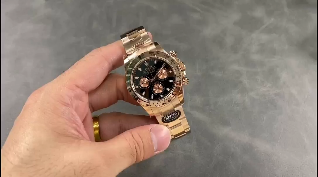 Video: hand holding Rolex Daytona 126505-0001, black dial and rose gold case visible. - Video
