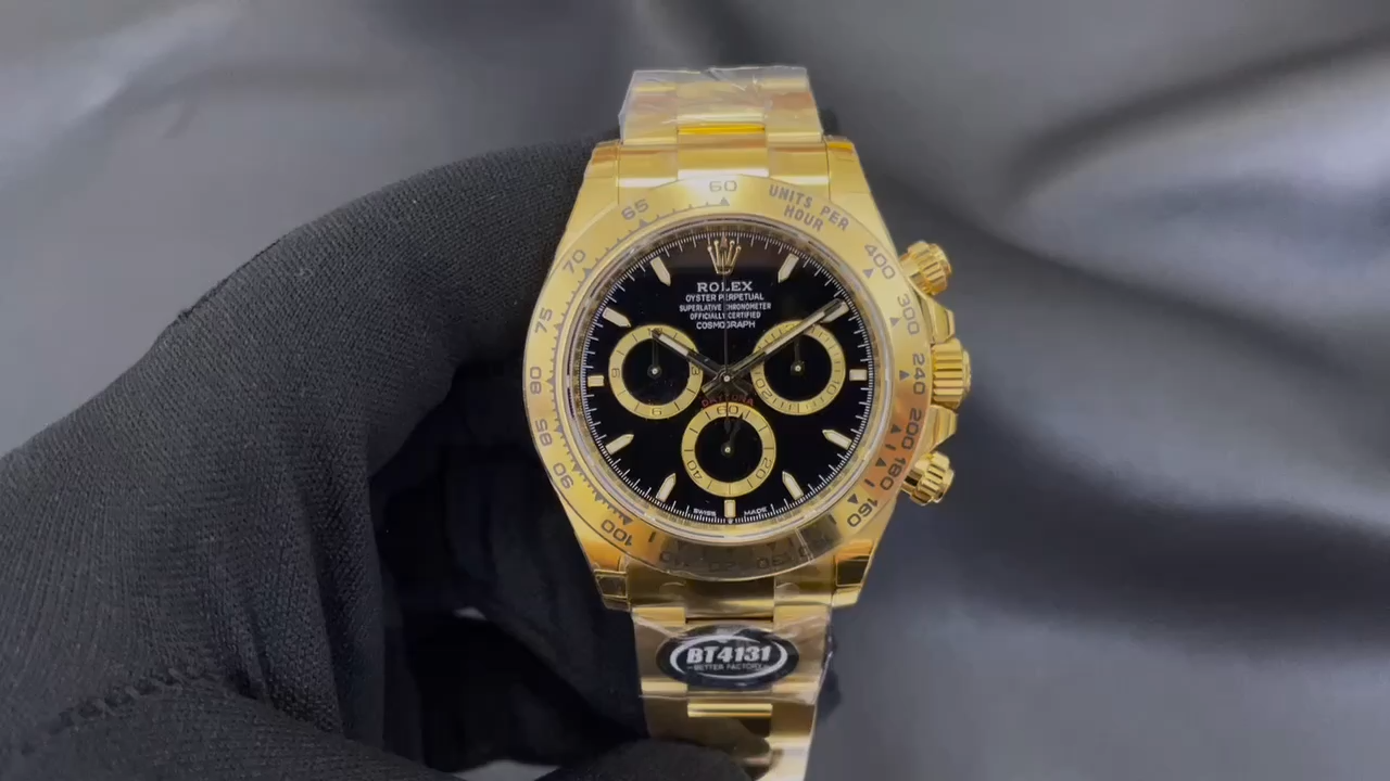 Video: gloved hand holding Rolex Daytona 126508-0004, black dial and gold bezel visible. - Video
