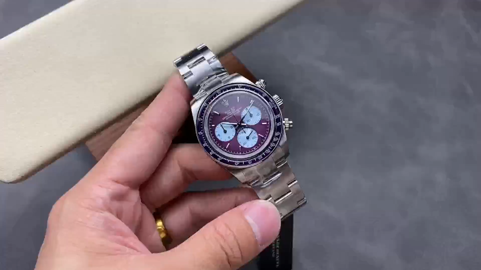 Shot of the Rolex Cosmograph Daytona 116520 showing the customized burgundy purple dial in natural light. - Video