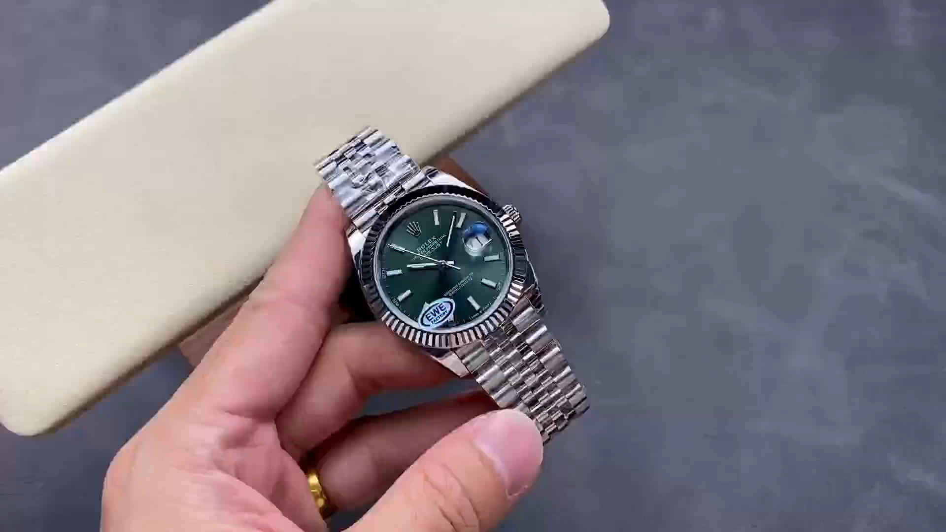 Handheld side view of the Rolex Datejust 126334-0028 showing the bracelet and case profile. - Video