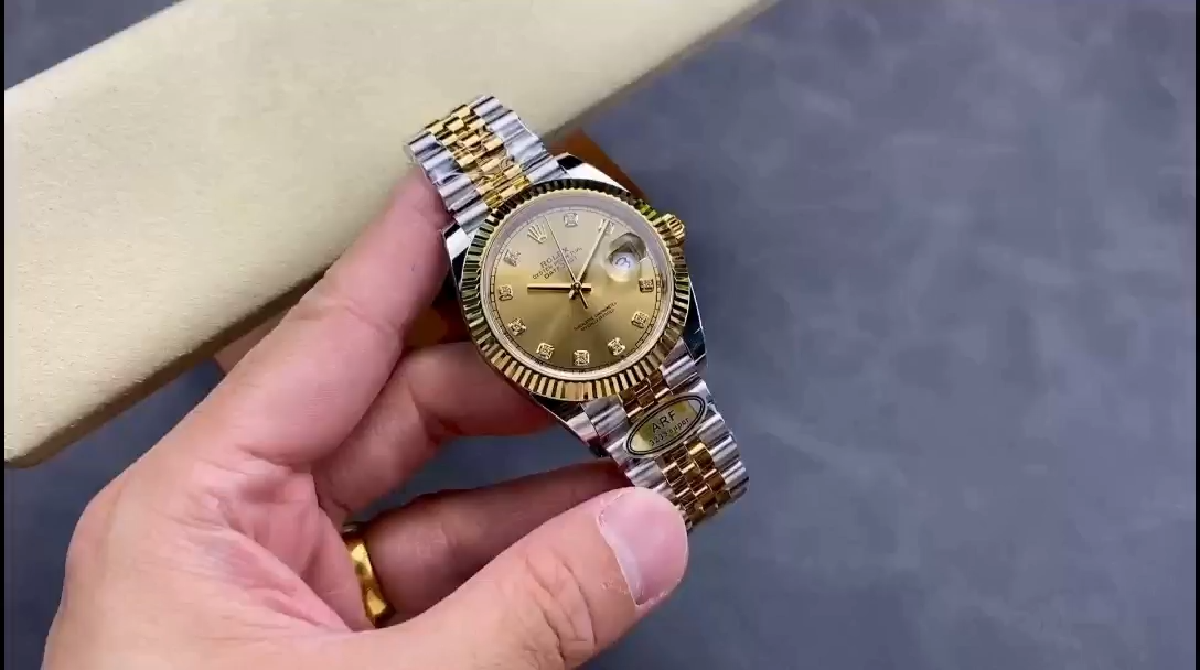 Hand-held angled view of Rolex Datejust M126333-0012 with fluted bezel and champagne diamond dial in focus. - Video